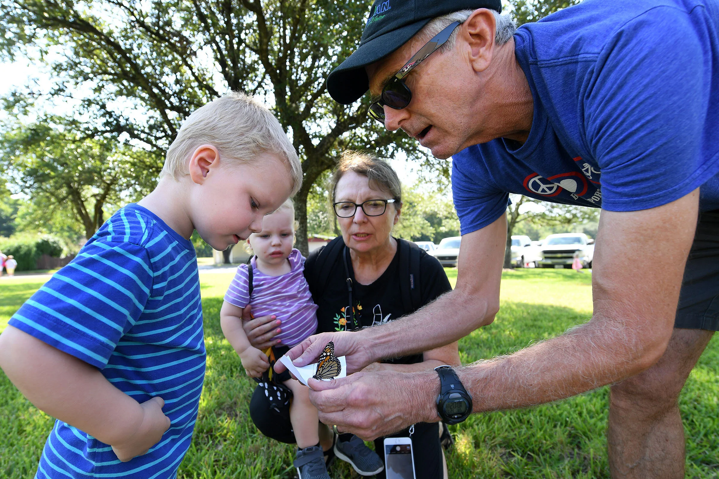 Ruthie Gray and Gary Kunkel release a monarch butterfly with their grandsons, Otis Gray, 2, left, and Walter Gray, 16 months, during the Brazos Valley Museum of Natural History's 7th annual Wish Upon a Butterfly event on Saturday, July 27, 2019, in Bryan, Texas. (Laura McKenzie/The Eagle)