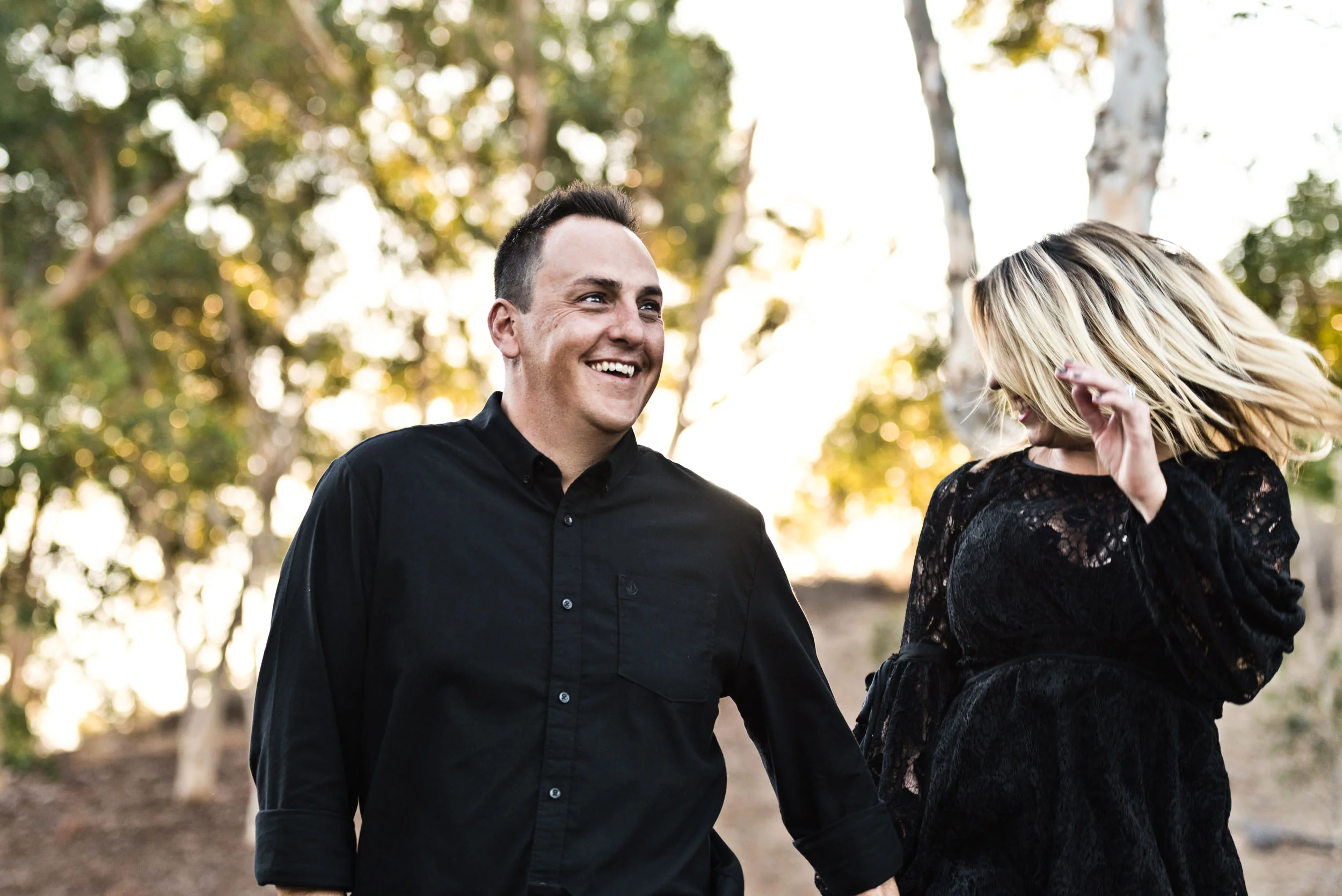 Mom and dad holding hands dancing in the park. Cedar Grove Park, Tustin, California.