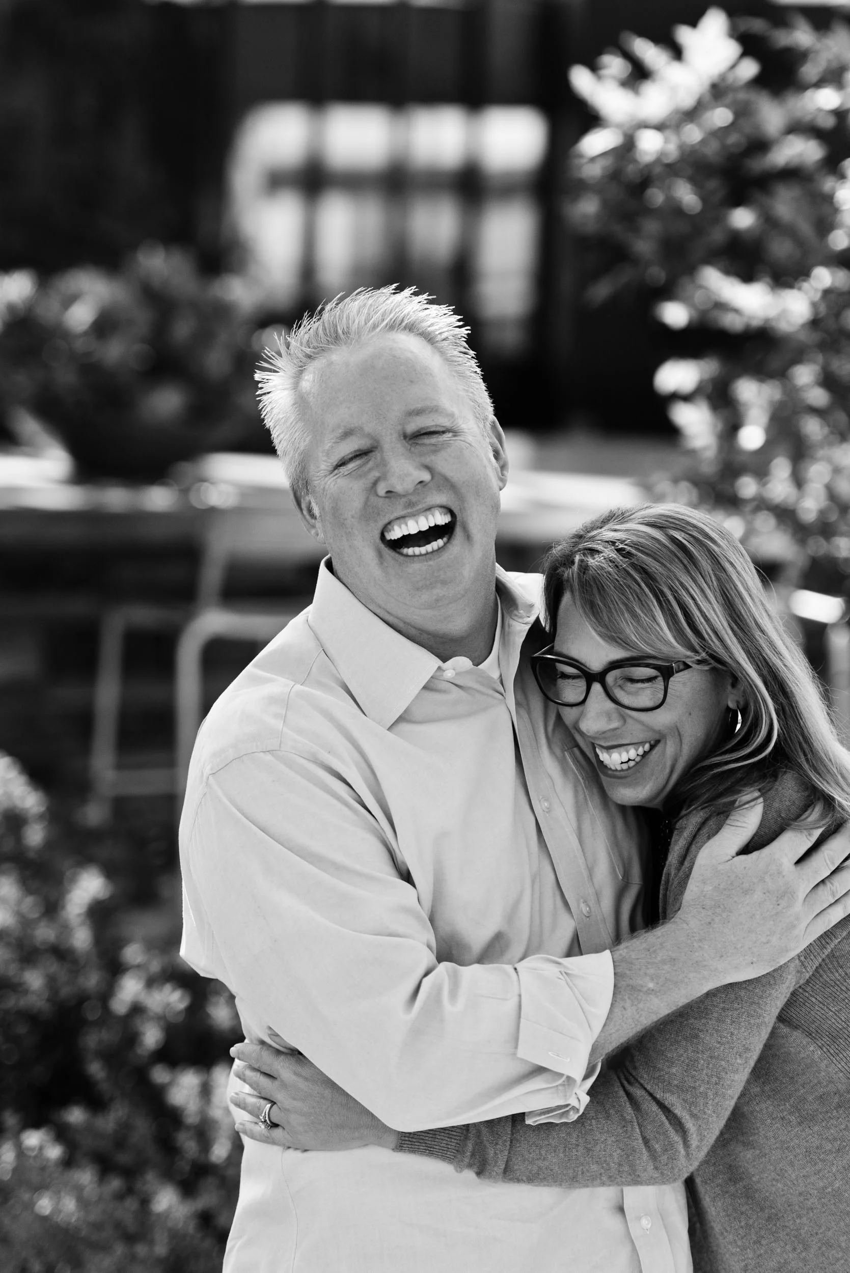 Dad and mom hugging and laughing. Beacon Park in Irvine, California.