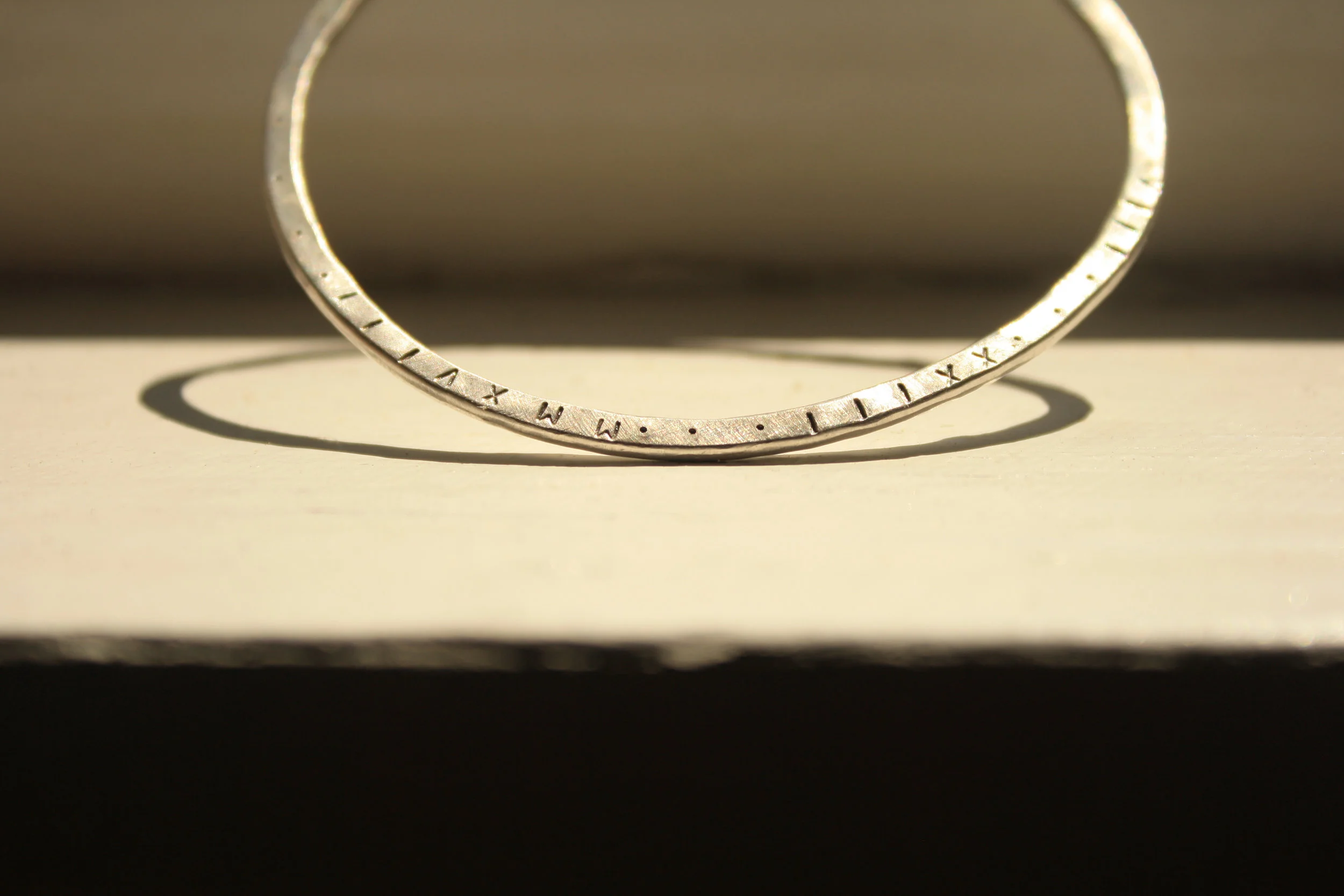 Roman numeral date bangle in sterling silver