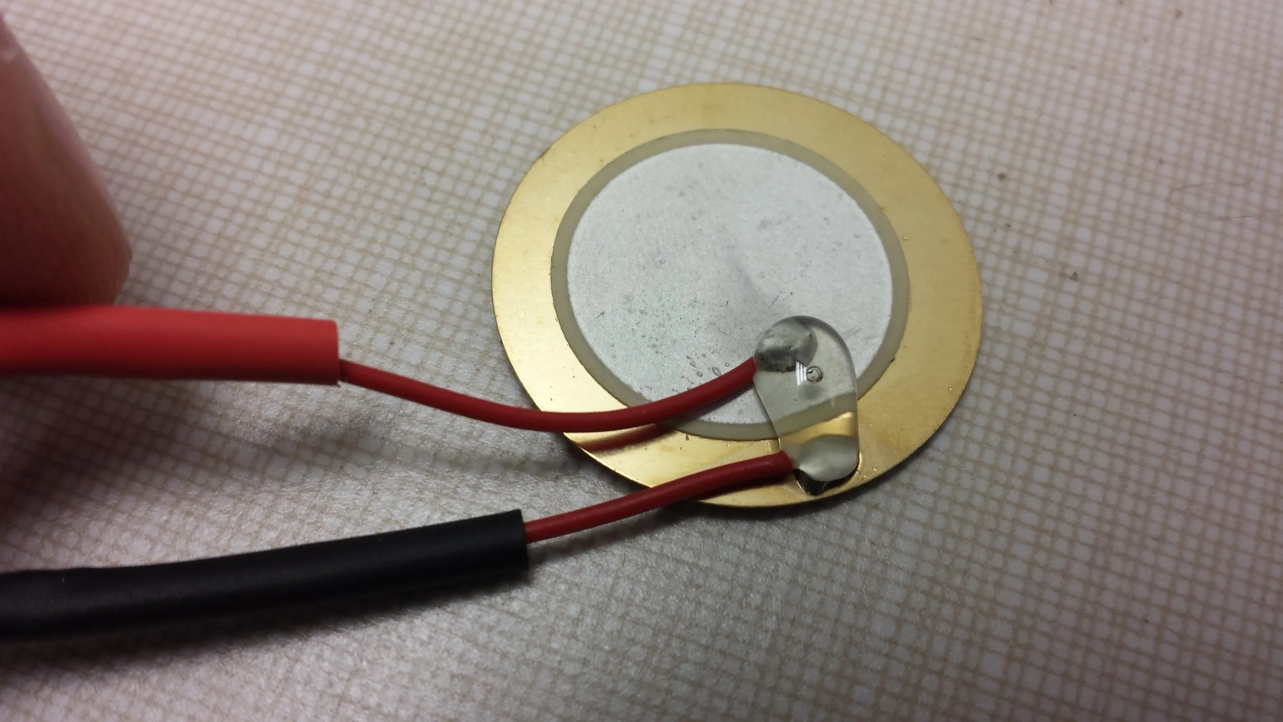 Hot glue between the two solder points also helped to prevent the ripping of wire