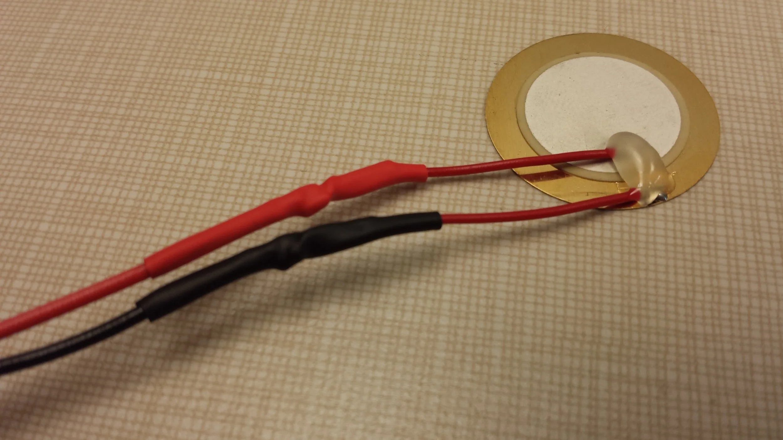 Heat shrink tubing around the wires helps to maintain the connection between the thicker and thinner wires.