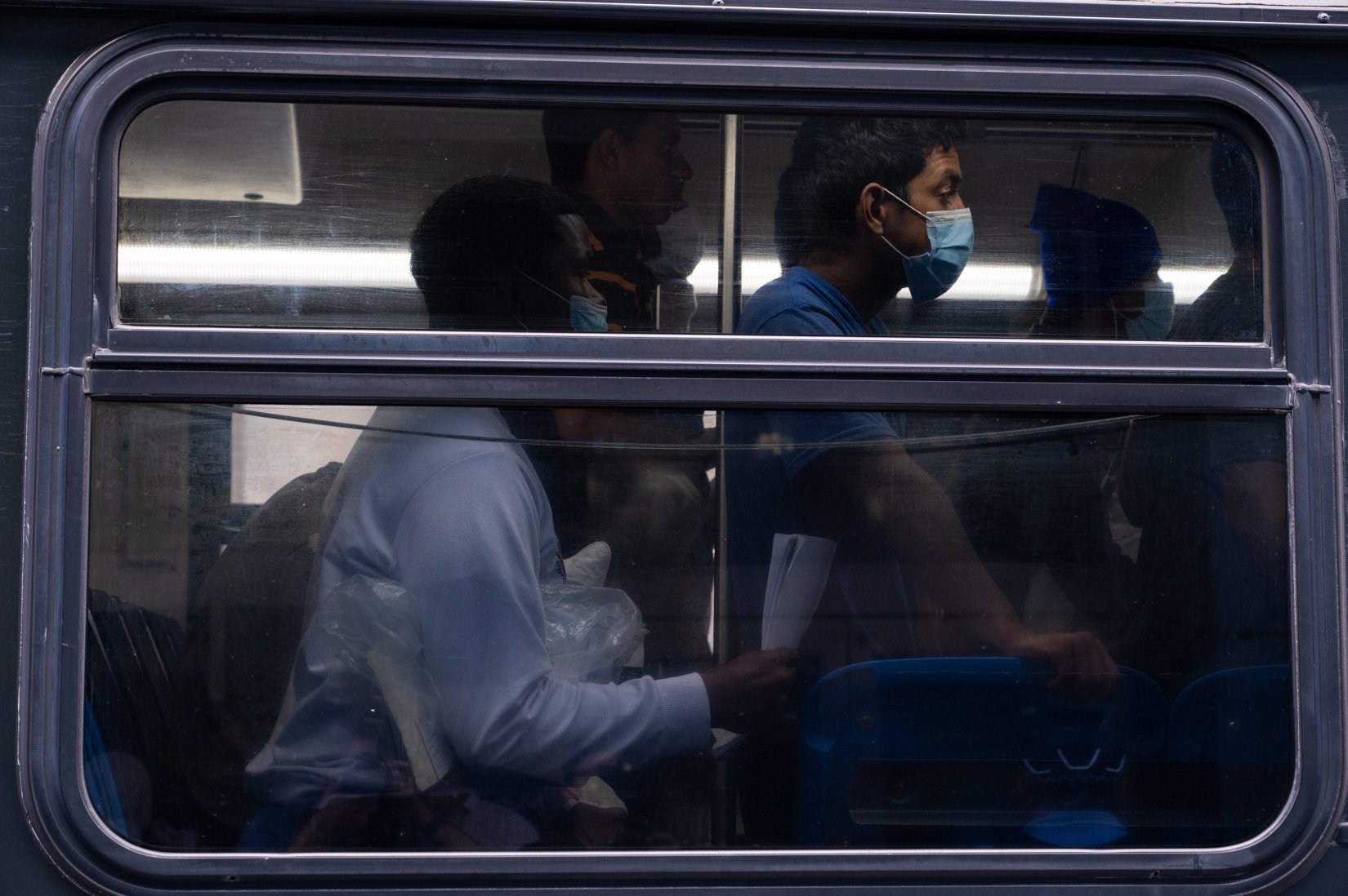  Migrants ride a shuttle after disembarking a bus at Union Station after a 25-hour-long ride from Texas on Sept. 9, 2022. | Colin Boyle/Block Club Chicago 