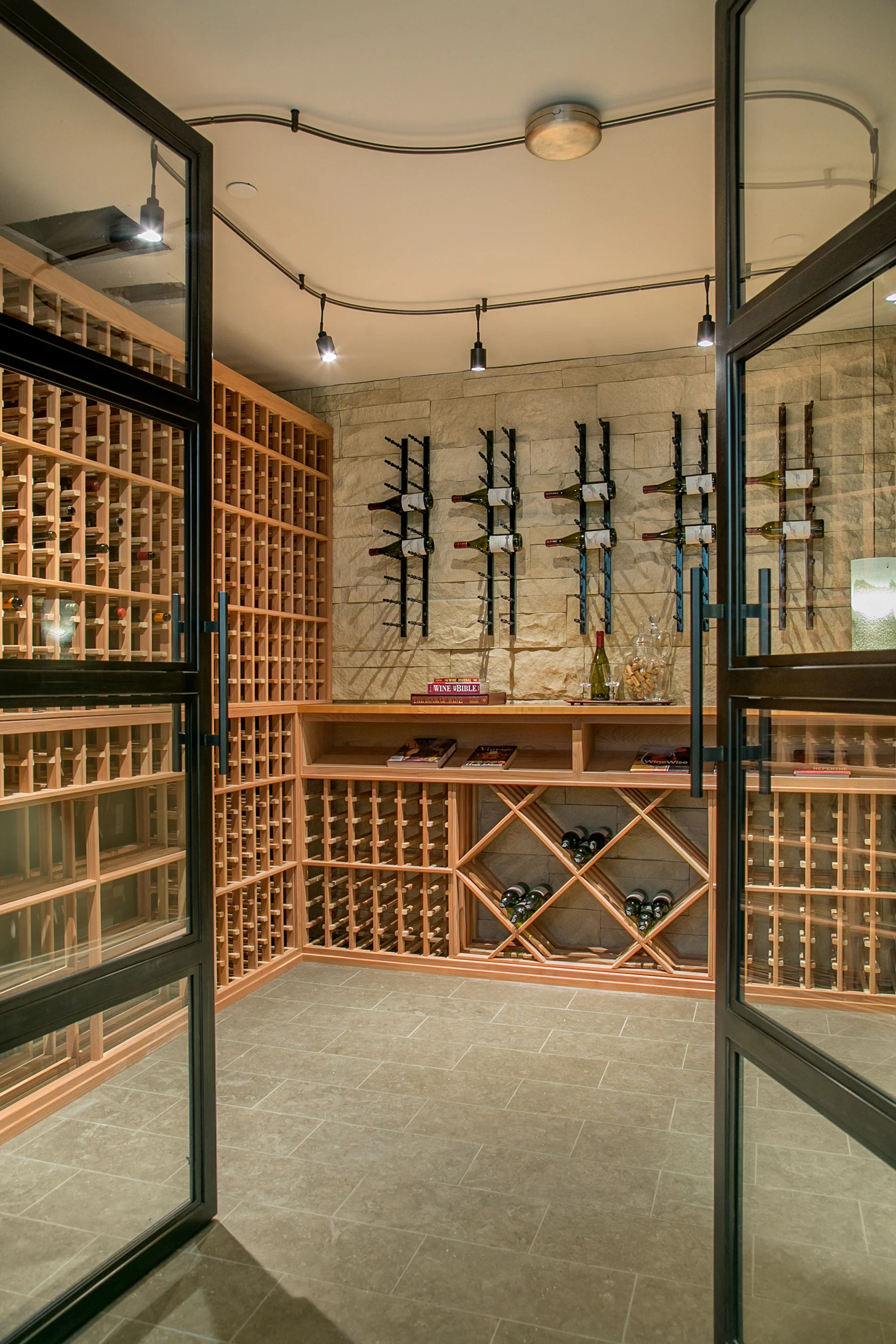 The wine cellar is less of a cellar and more of a tasting room; with space for more than 1,000 bottles & secured by custom steel and glass doors.