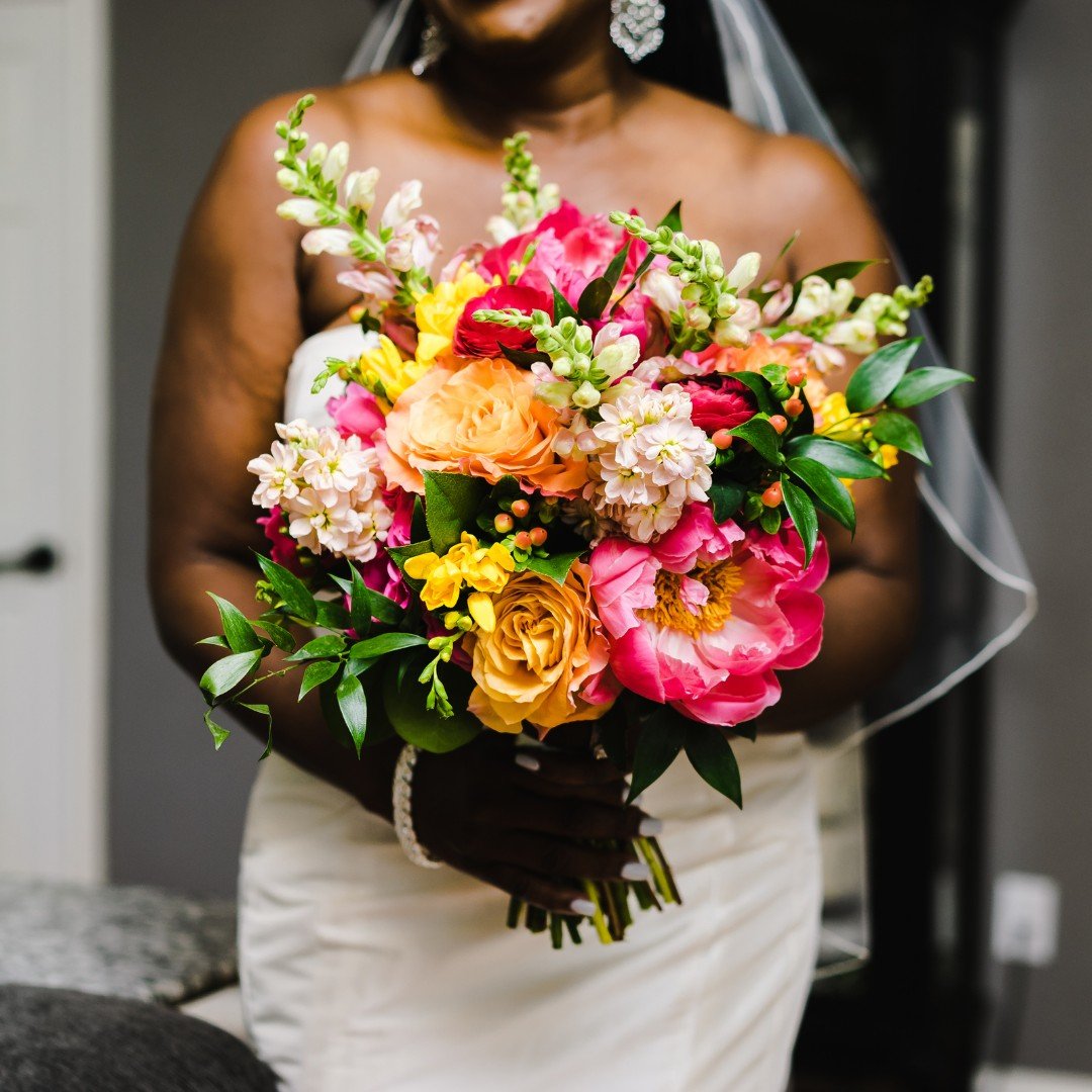 From vibrant blooms to lush greenery, this bouquet is a reflection of the bride's radiant spirit and the blossoming journey ahead. Each petal holds a promise, each color a sentiment, combining to create a masterpiece that complements her glow on this