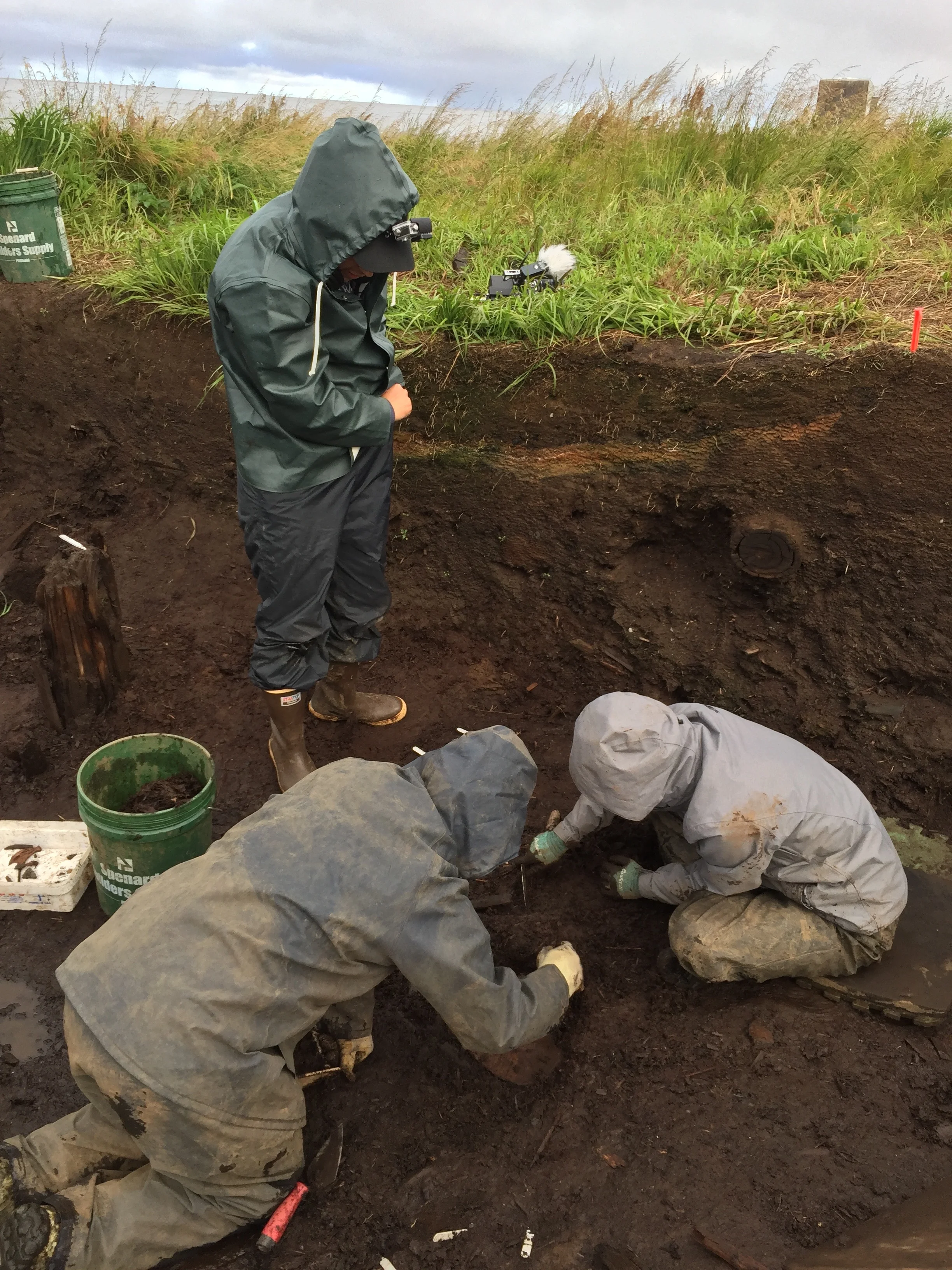 Josh Branstetter, Rick Knecht, Lise Bos all working on uncovering objects in the house floor of the Nunalleq Site.