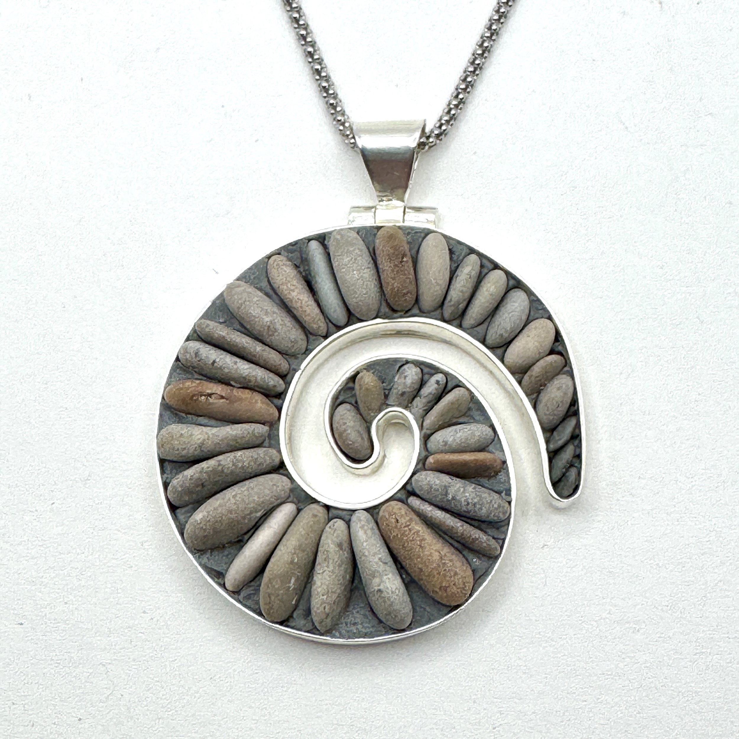 Natural pebble small koru necklace.jpeg