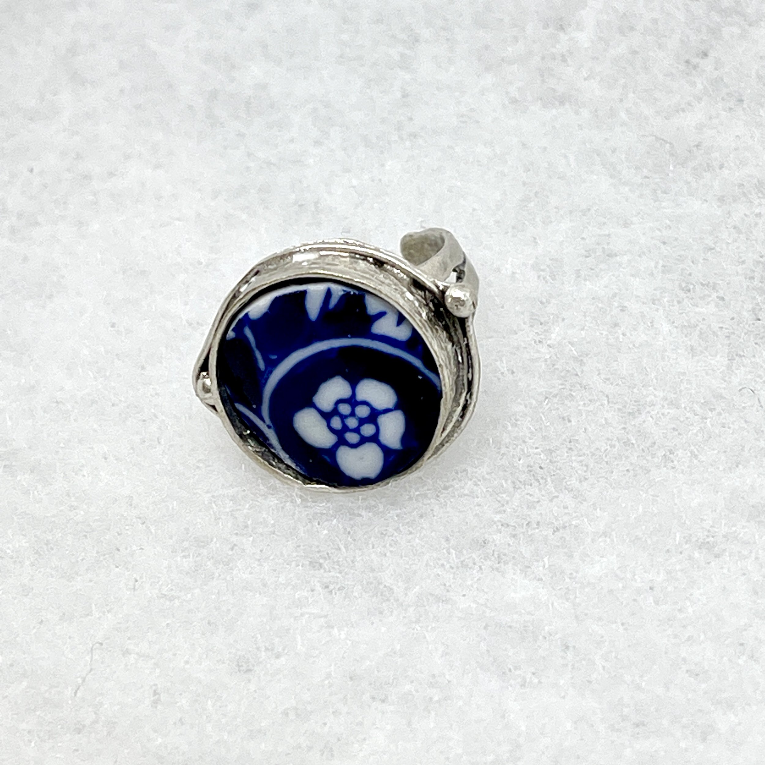 White Flower on Blue Circle Ring.jpeg