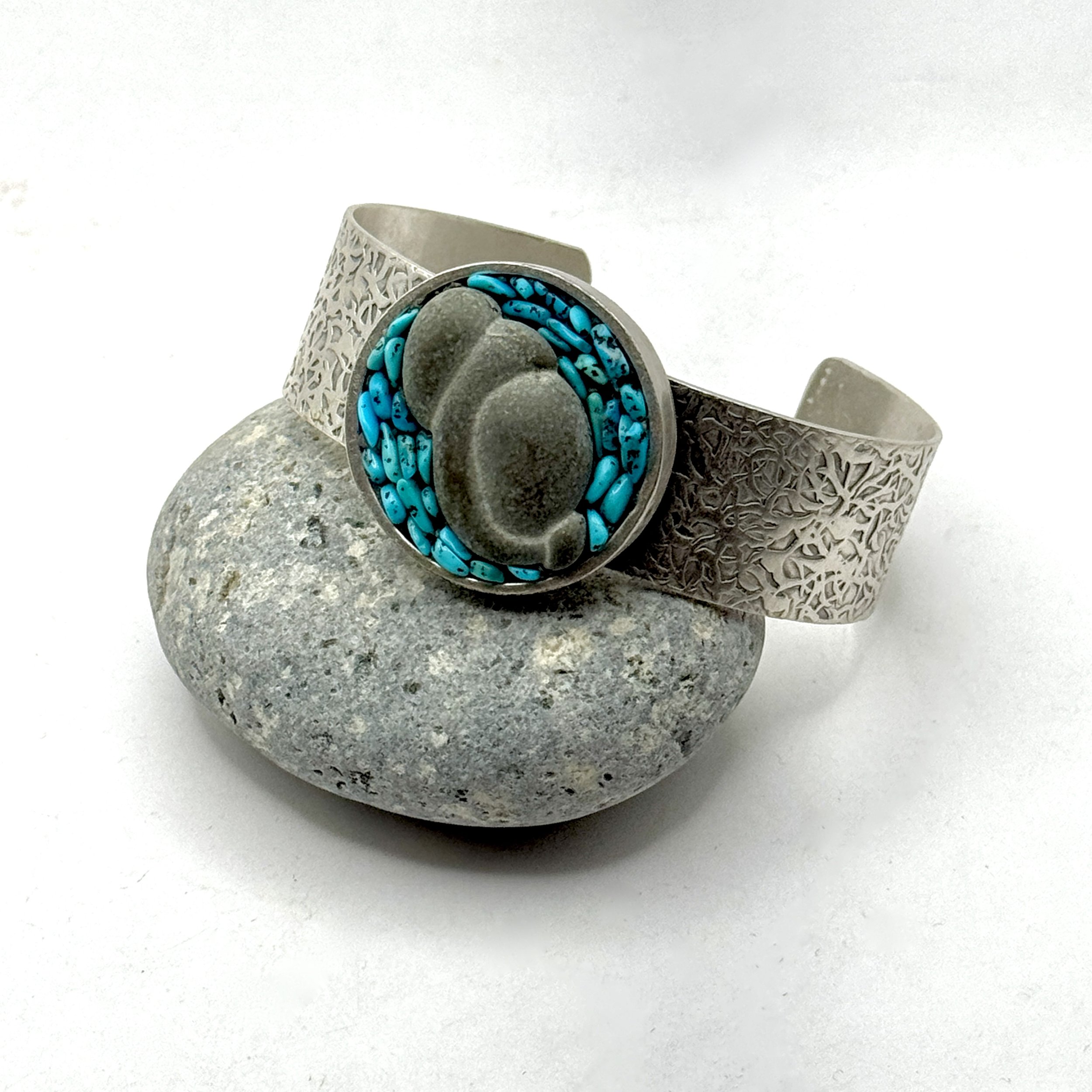 1 3/8” circle on 3/4” wide band, hammered silver plate with a goddess stone and genuine turquoise nuggets