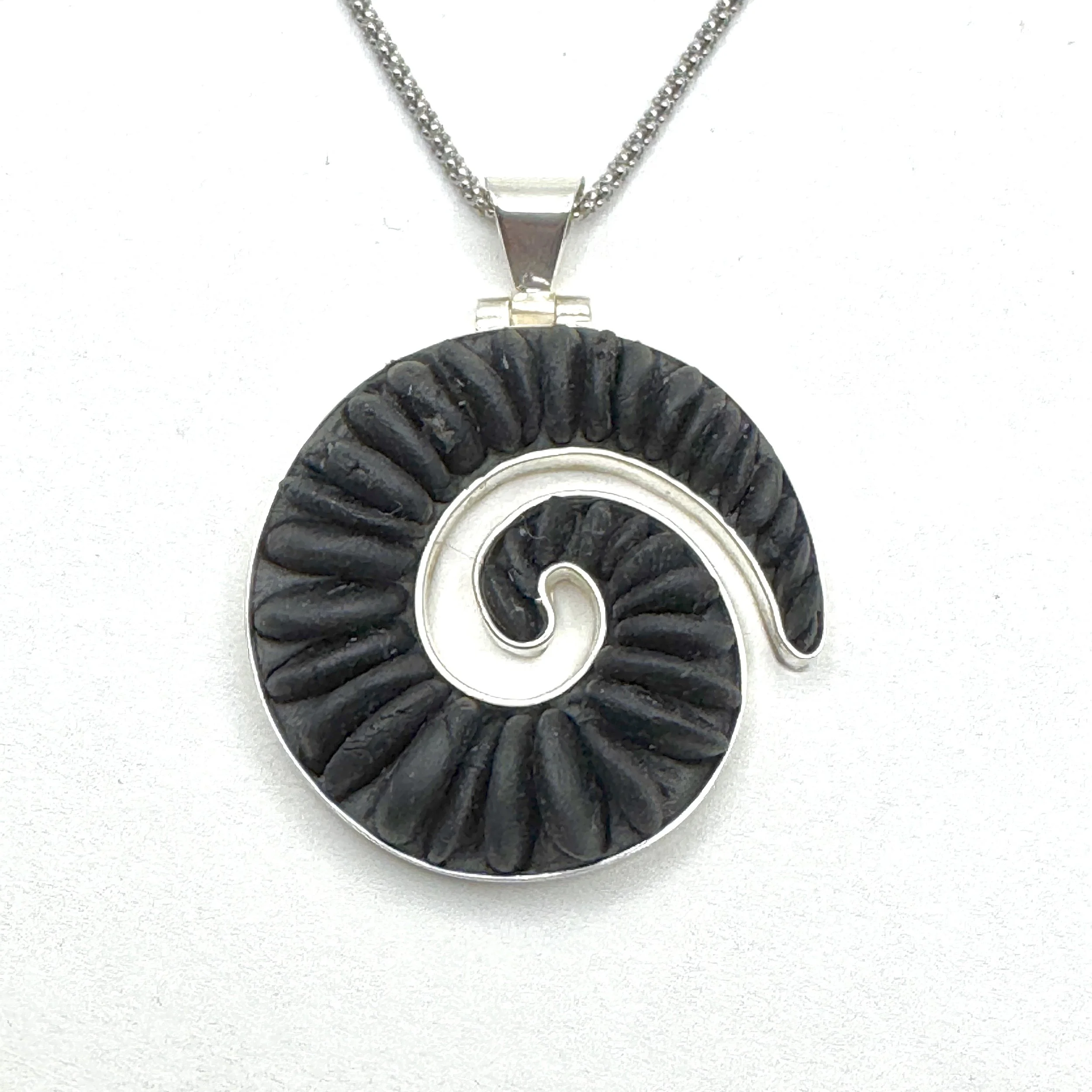 Black pebble small koru pendant.jpeg