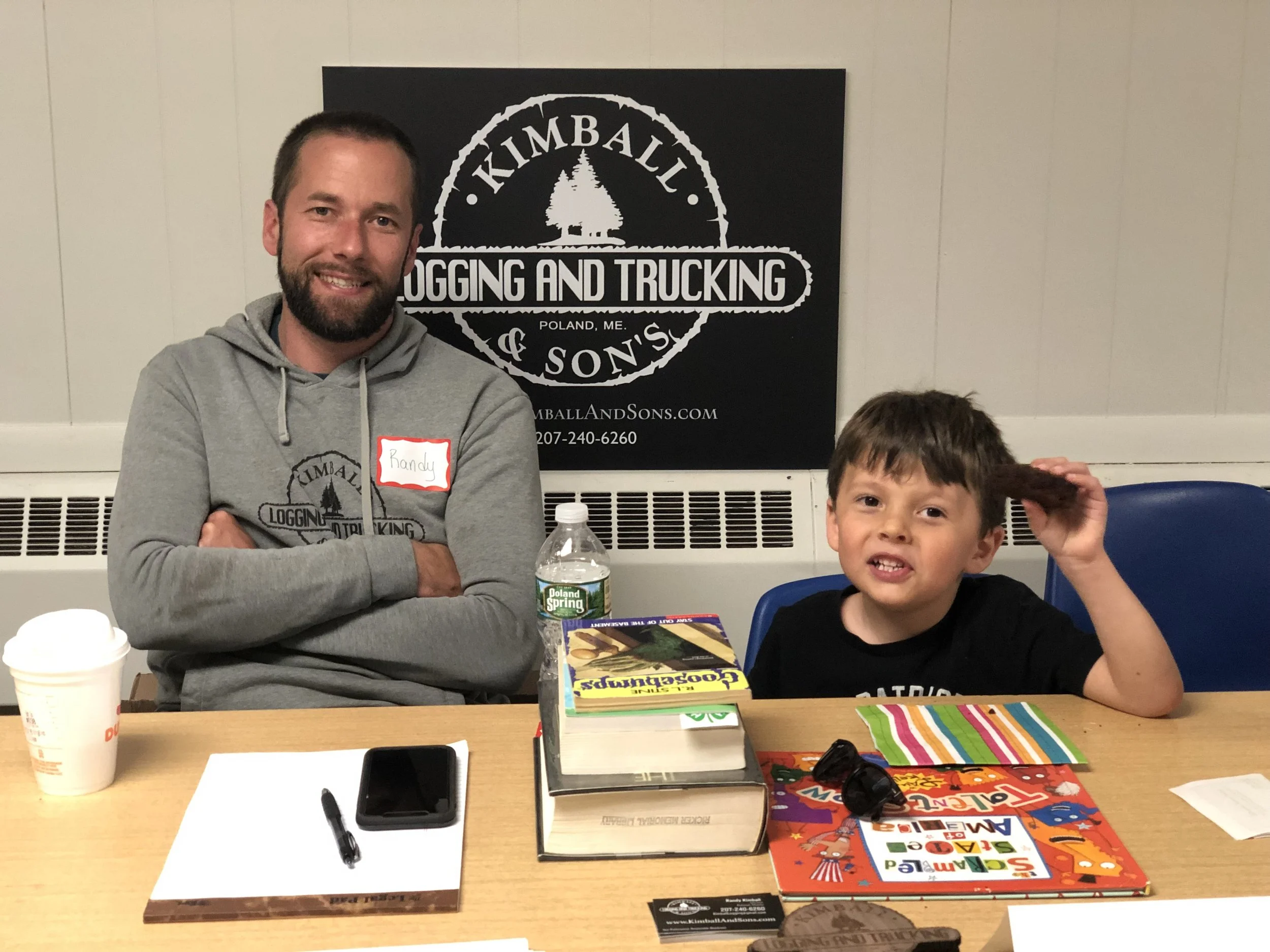 Gard is demolishing a brownie while we teach people about logging!