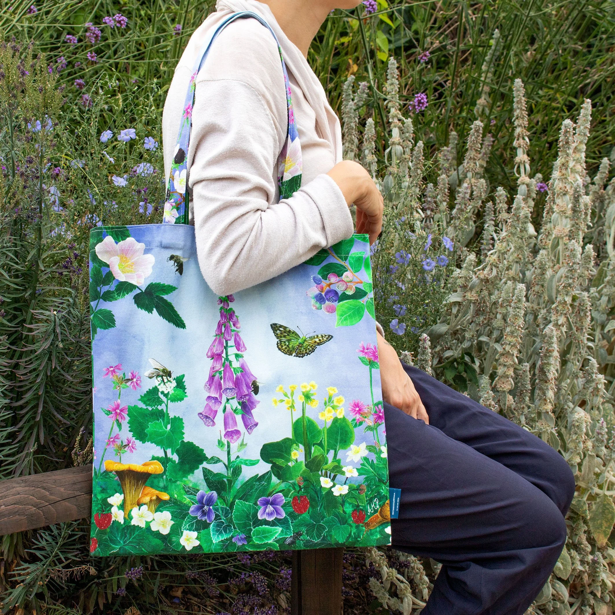 A Woodland Walk Tote Bag-front-sitting on bench surrounded by flowers and greens-01.jpg