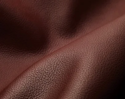 aniline leather Leather that hasits grain surface substantially intact which is dyed but has not received a pigmented coating. The grain layer extends from the grain surface to the hair roats .