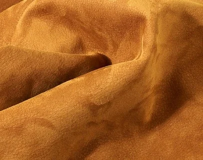 nubuk leather Its top-grain leather that has been sanded or buffed on the grain side or outside to give a slight nap of short protein fibers , producing a velvet like surface . It is usually from cattle hides but deerskin and lambskin nubuk . Nubuk leathers are noted from their exceptional softness. Nubuk leather can be dyed in a varaiety of colors and treated for a selection of special finishes such as distresses , antiqued or shrunken effects . 