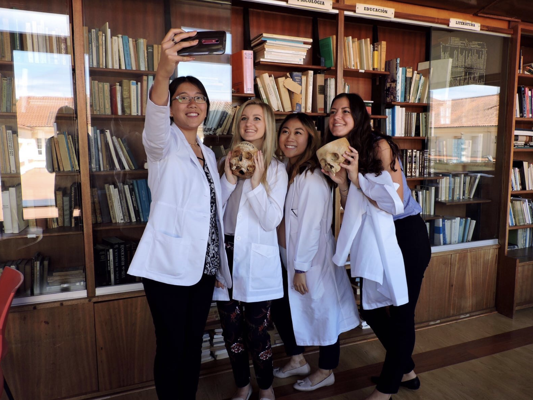 Us taking a silly picture in Santiago with some of the skulls in the library.