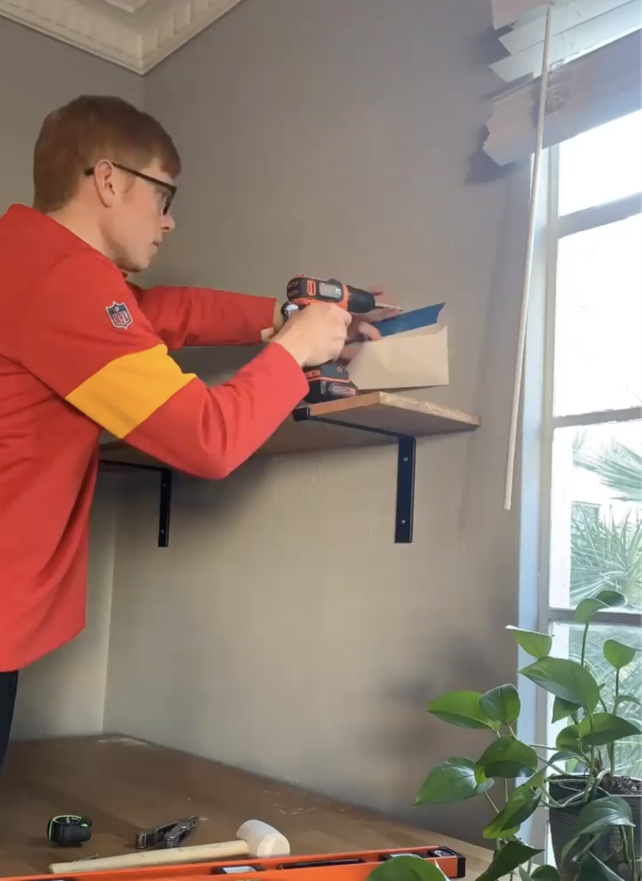 Installing custom shelves with brackets and stained wood for a home office