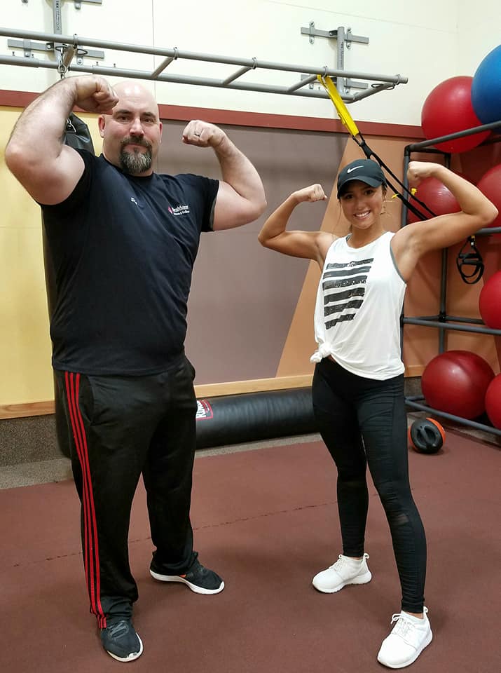 two trainers flexing 