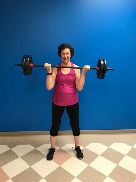women with barbell.jpeg