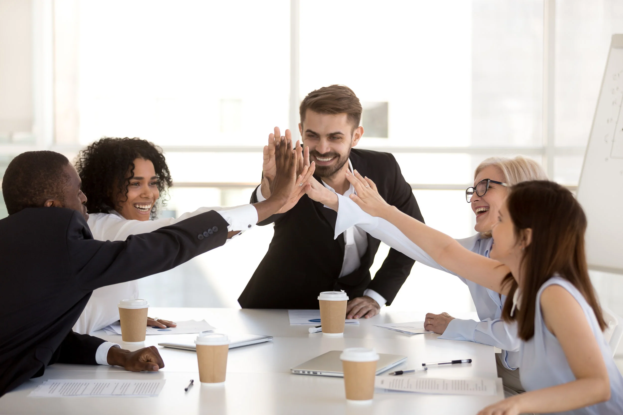 shutterstock_1233219739 coworkers around table.jpg