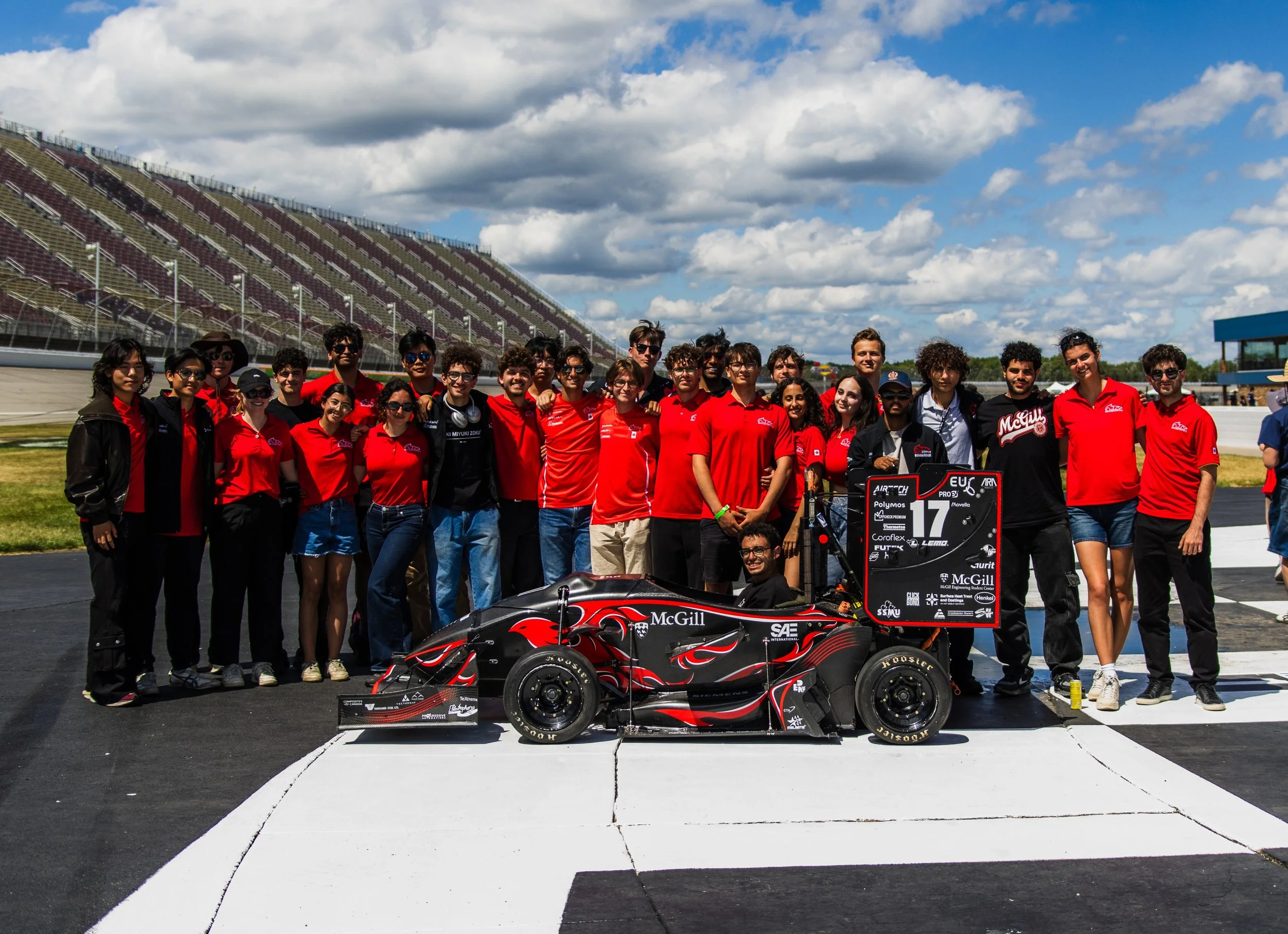 team pic behind car.jpg