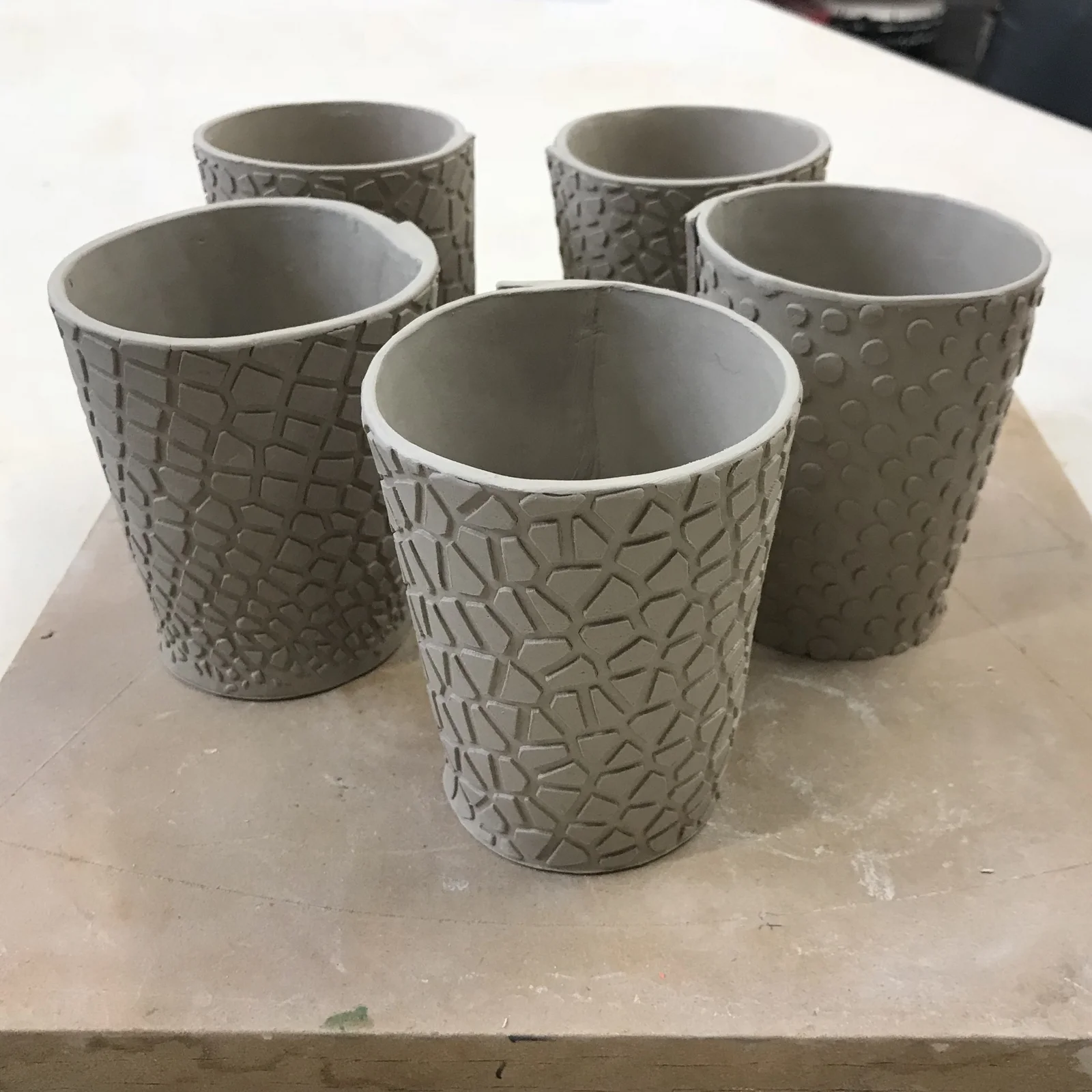 Cups in wet clay.