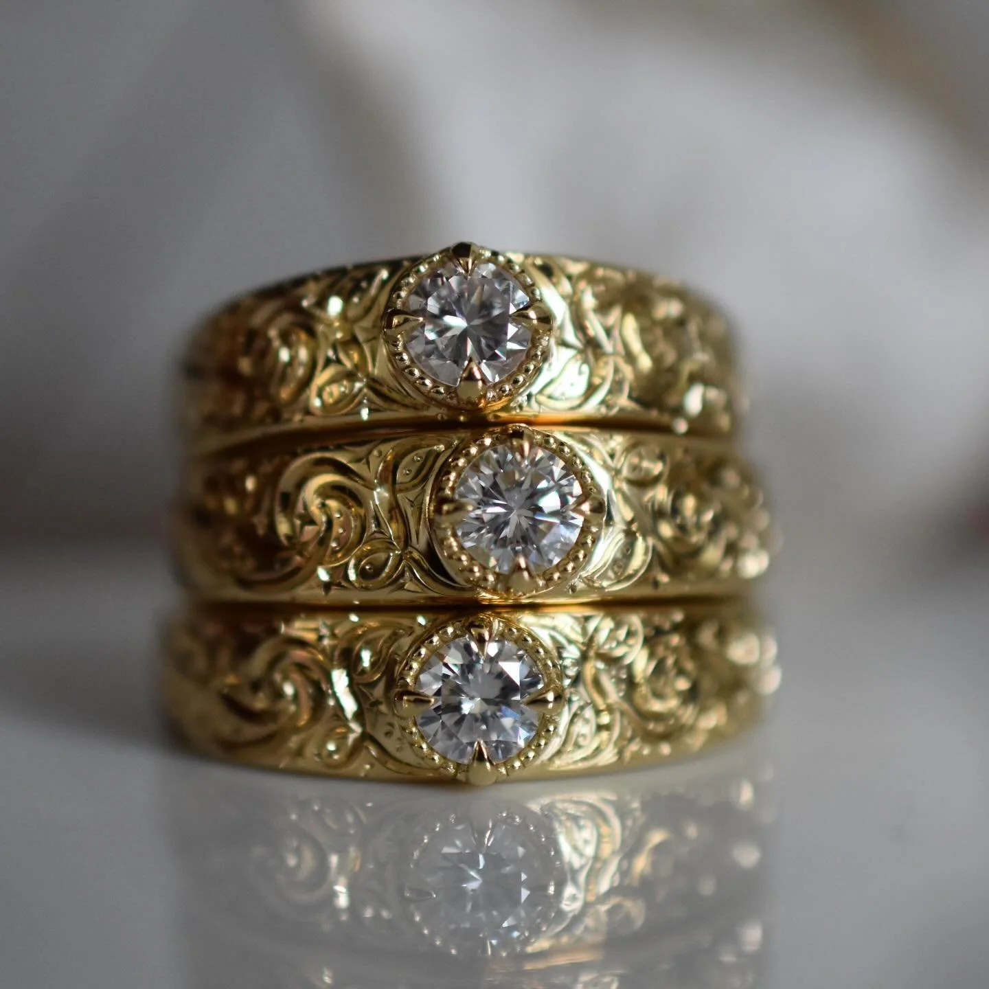 My client came to me with an heirloom three stone ring. She had the idea that she wanted to take it apart and use the diamonds to make herself and her daughters matching rings with my nightsky engraving. Of course I loved the idea and was happy to ma