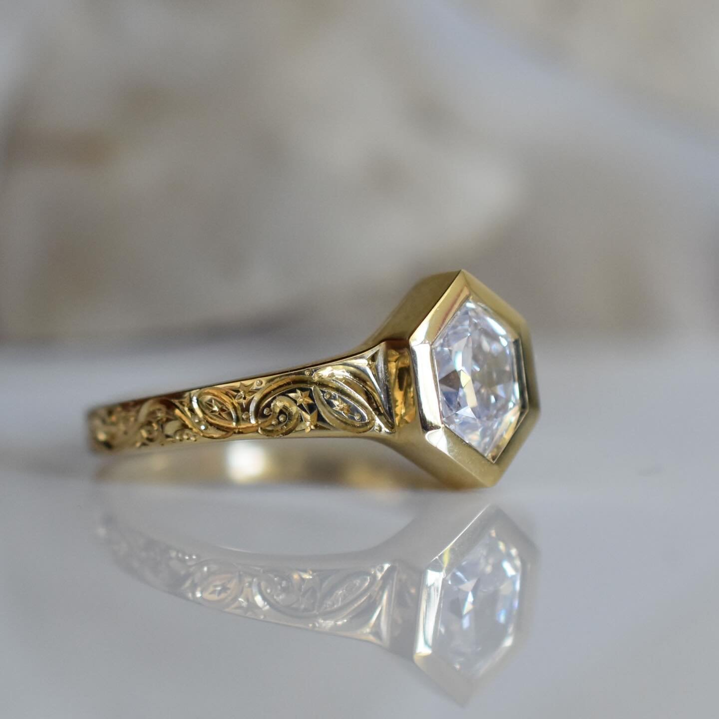 I&rsquo;ve got a new Wren available✨ 
This one I&rsquo;ve set with a natural diamond sourced from @misfitdiamonds 
18k gold and finished with hand engraving of my nightsky pattern. 
Please dm for details ✨