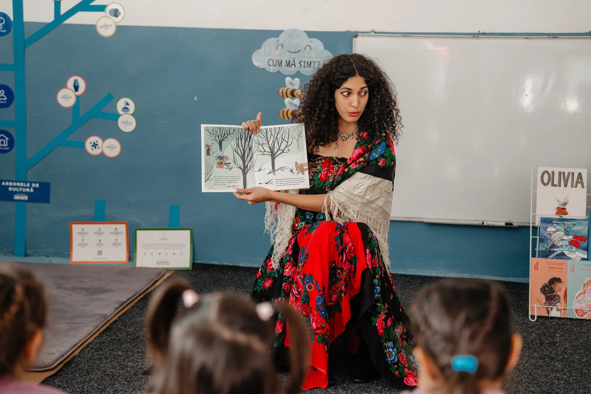 Arina Costea citind cartea scrisă de ea cu copiii