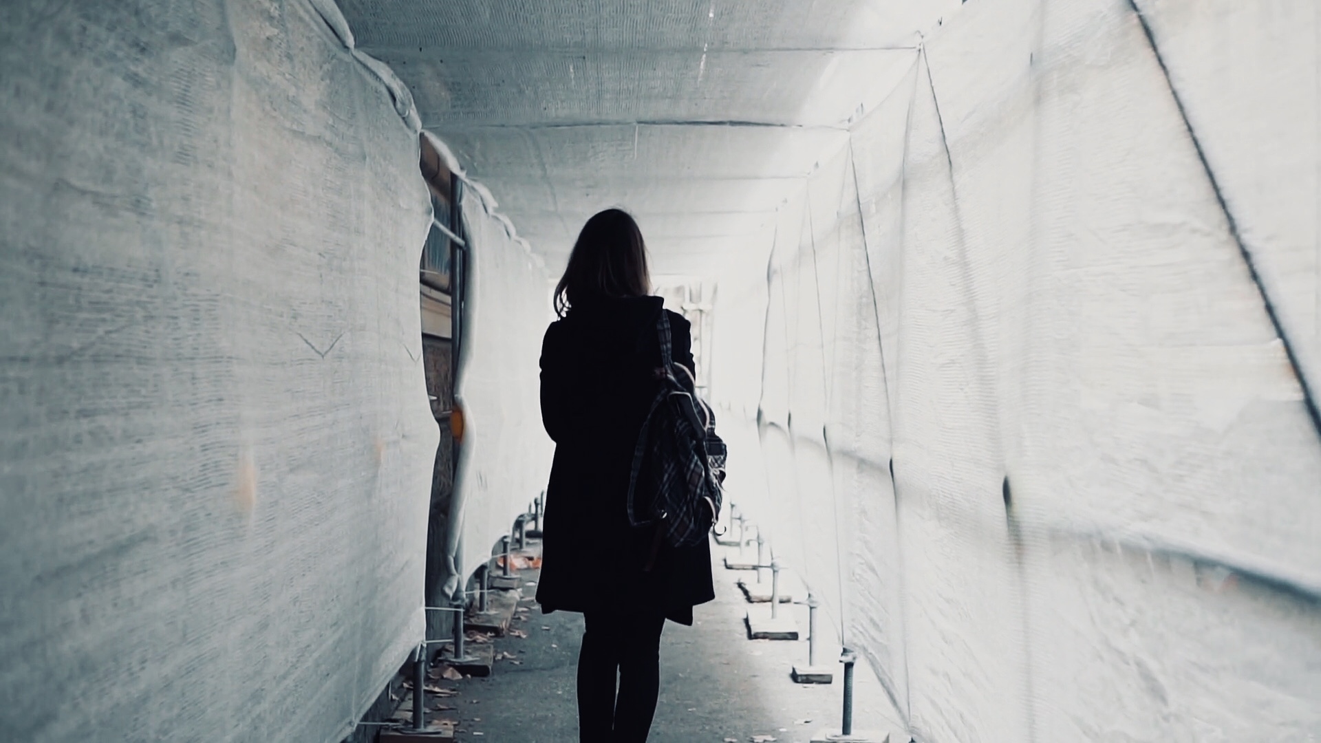 videoblocks-student-girl-walking-through-the-white-construction-corridor-back-view-of-young-woman-goes-to-work-across-the-building_rnllt3ldje_thumbnail-full08.jpg