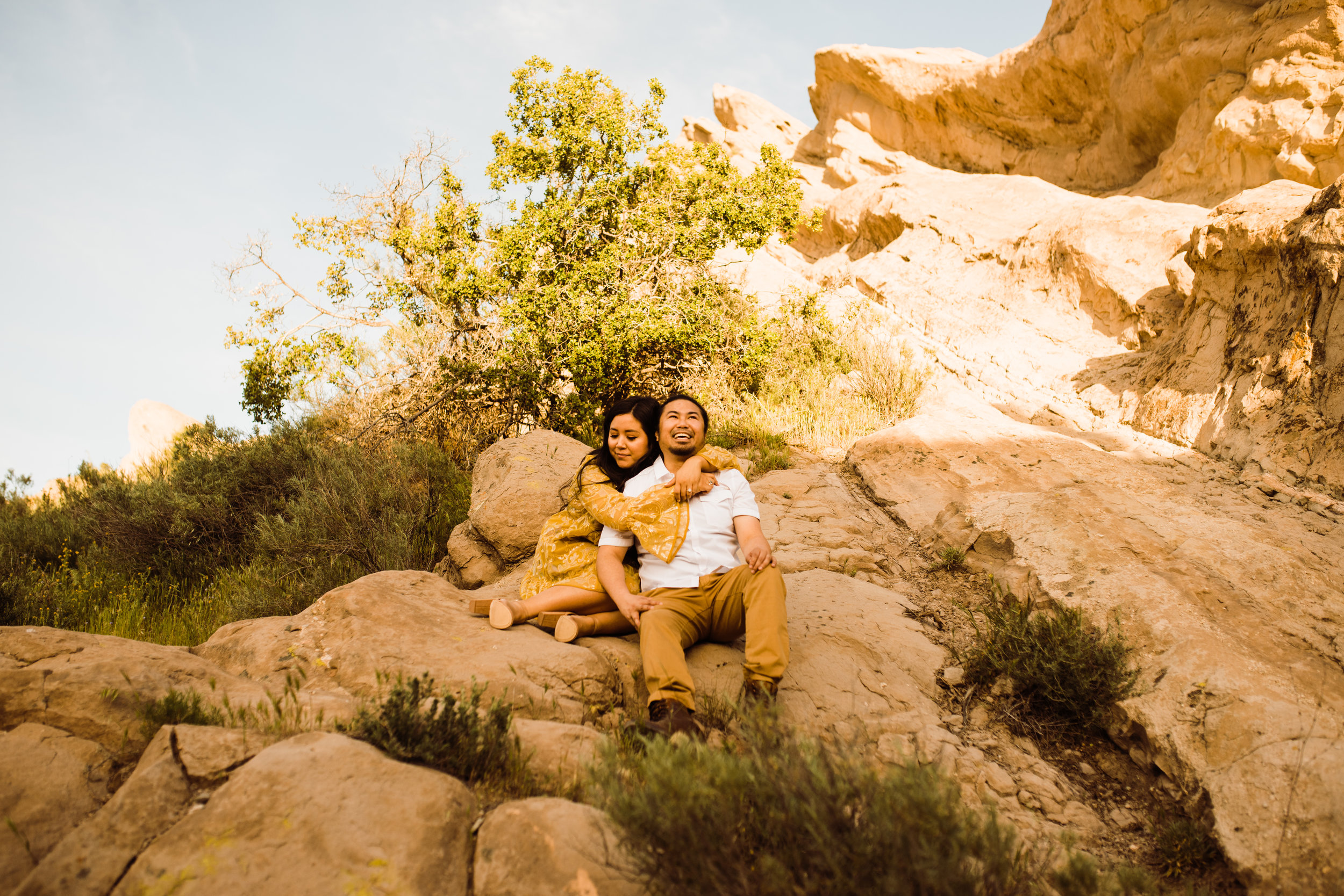 Engagement Shoot at Vasquez Rocks, Santa Clarita | couple in yellow-themed outfits on slanted rocks | adventurous elopement photographer Kept Record | www.keptrecord.com