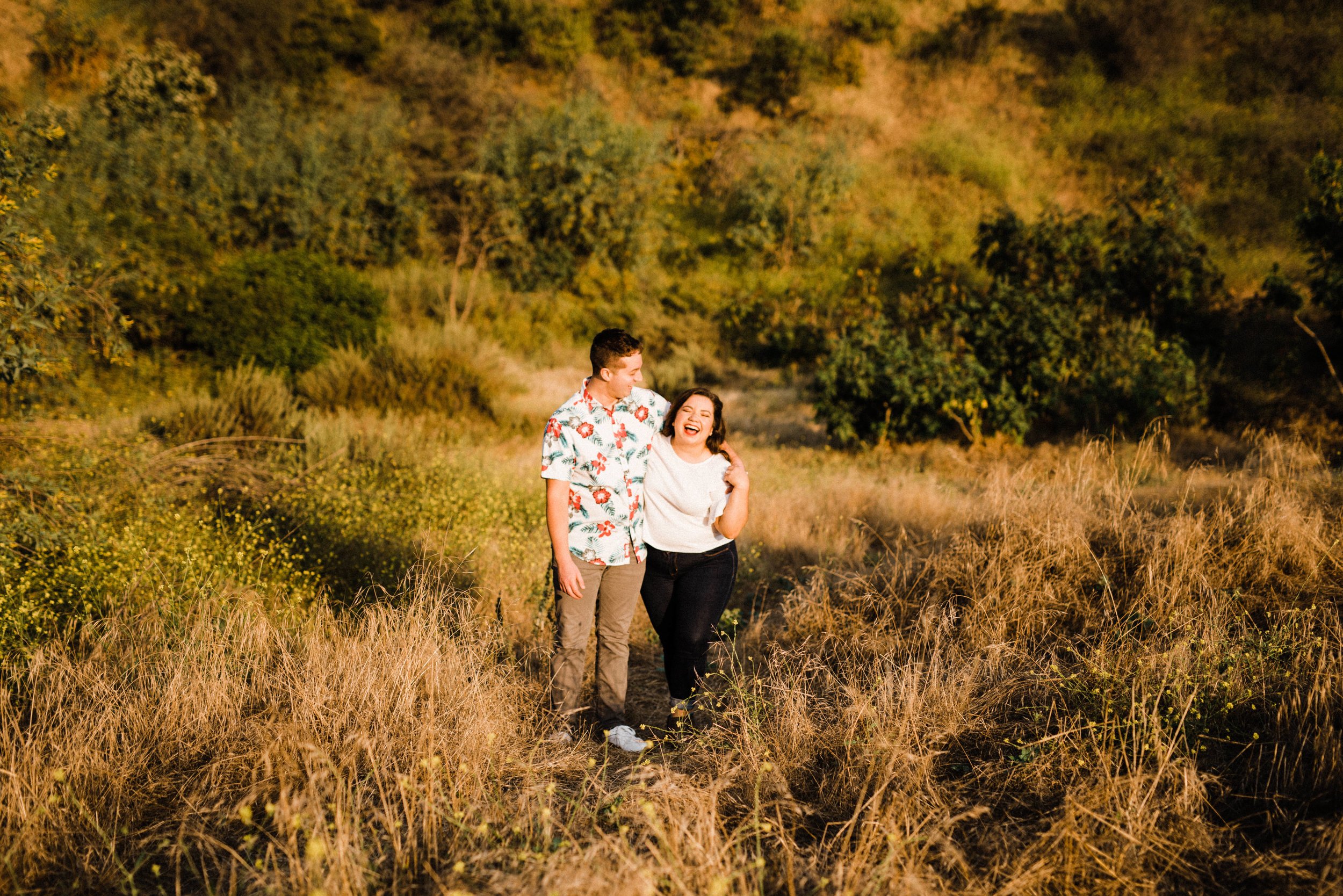 Couple walking on a trail at Bronson Canyon for their adventurous engagement shoot