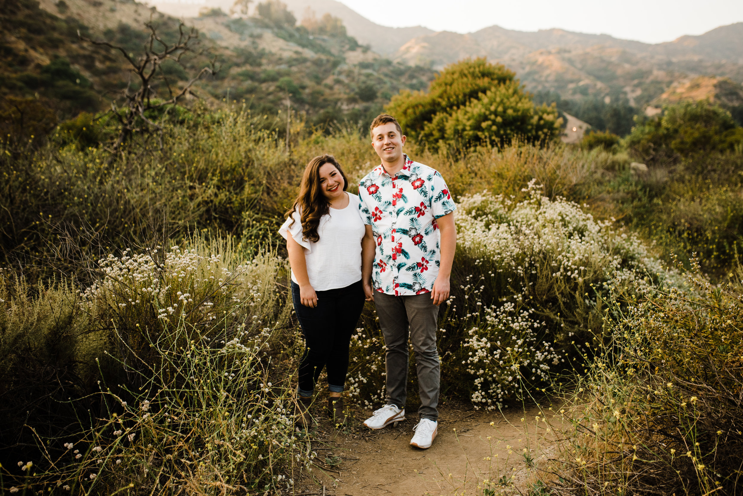 Couple smiling at their adventurous Los Angeles engagement session this summer.