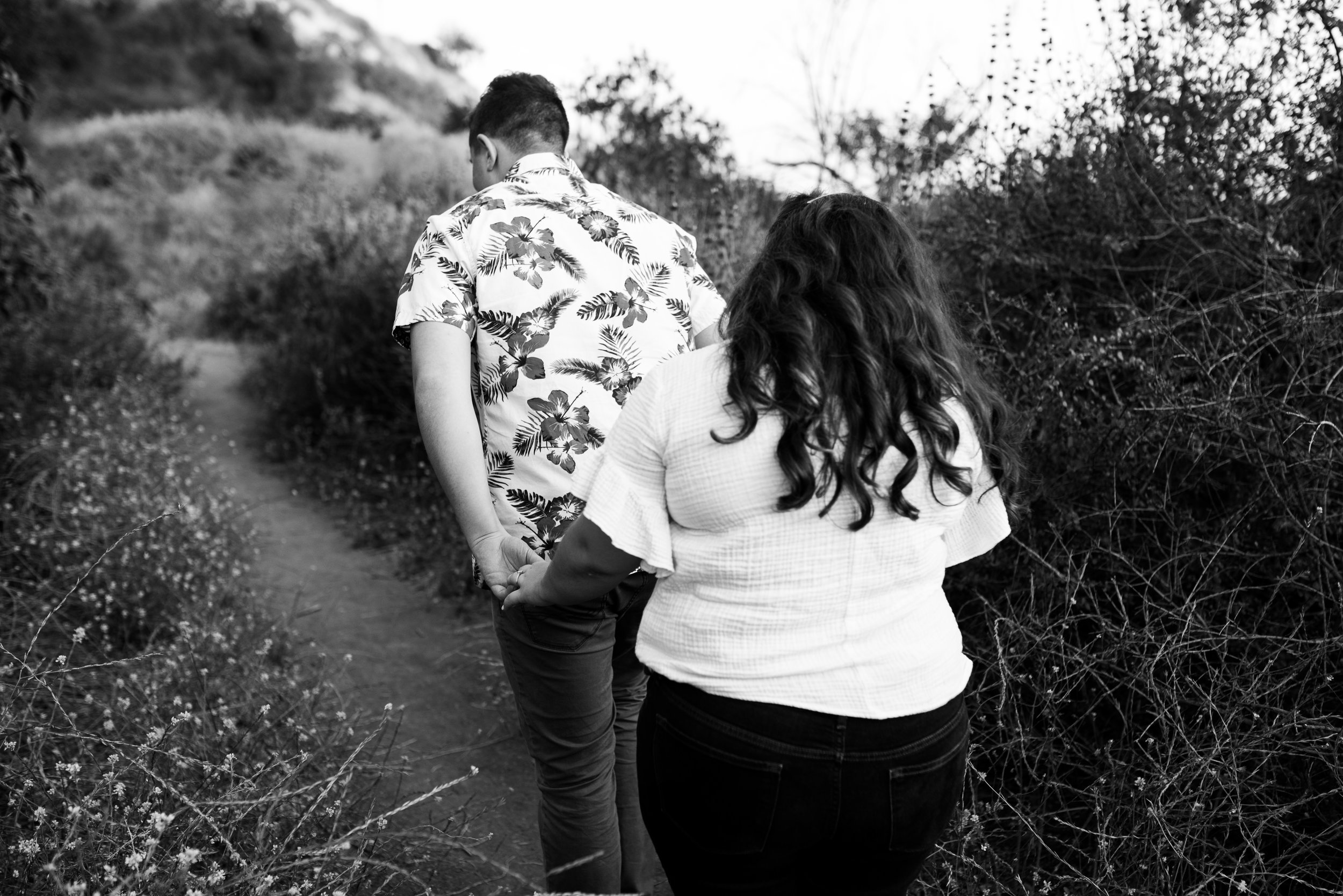 hipster couple walking the trails of Bronson Canyon for their adventurous Los Angeles engagement session