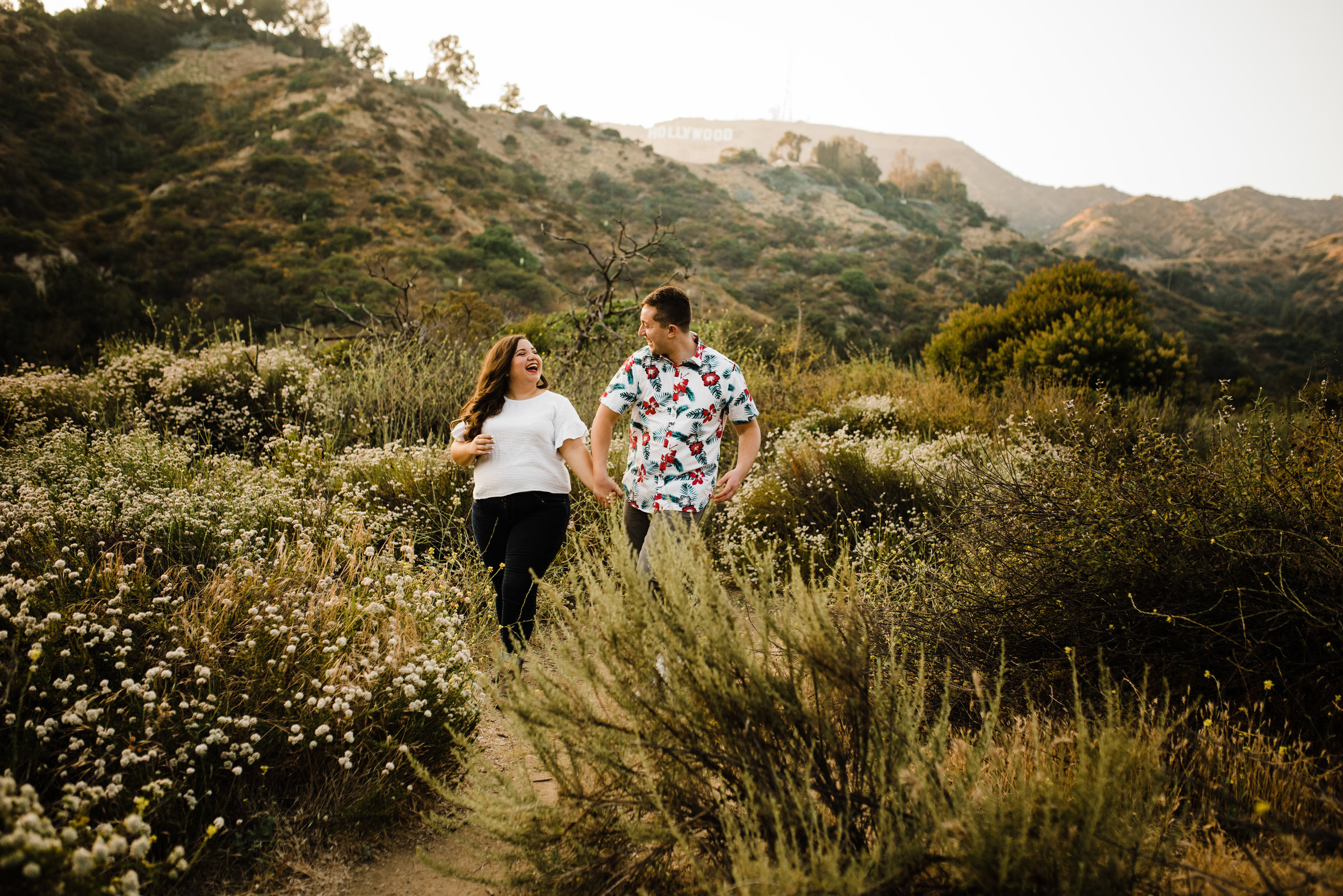 Couple hiking the trails of Bronson Canyon for their adventurous Los Angeles engagement session