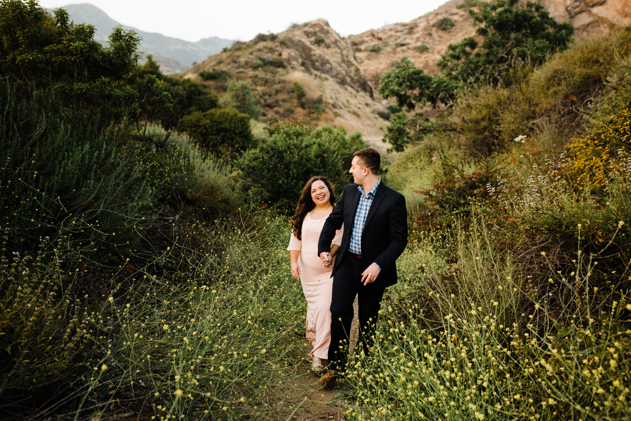 Adventuring through LA's Bronson Canyon, engaged couple walking together