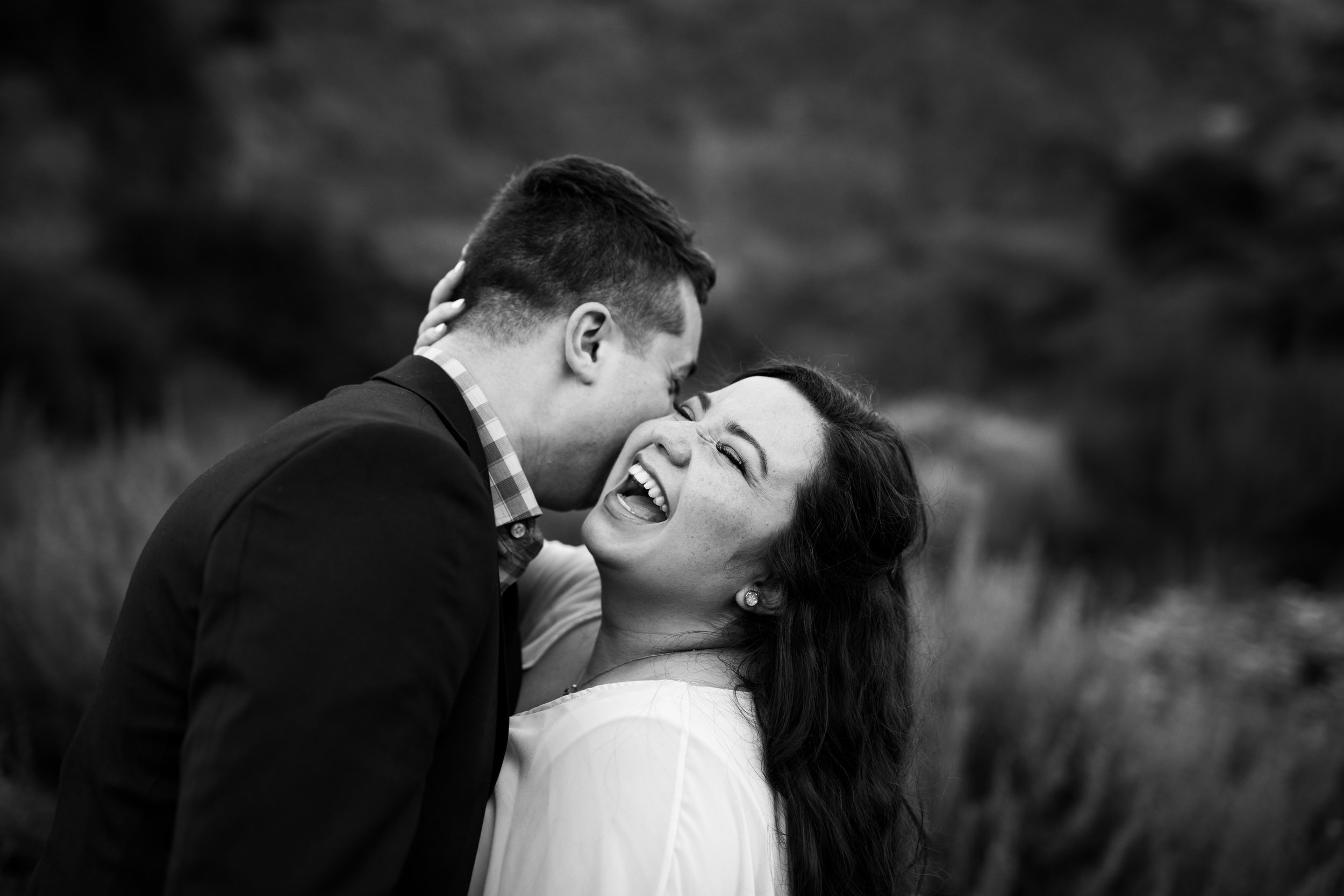 Engaged Couple Laughing at Bronson Canyon in Los Angeles after an adventurous engagement session
