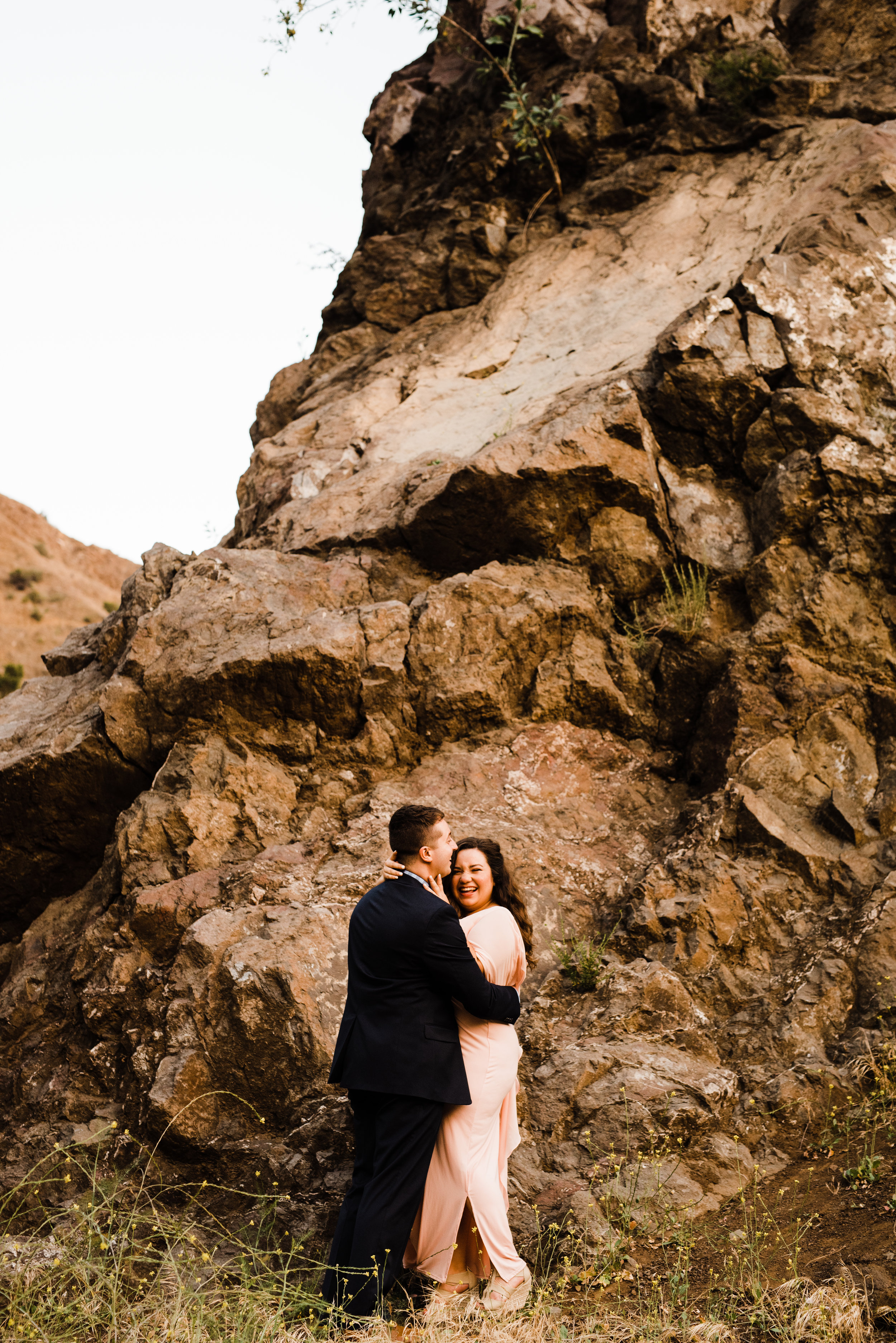 Couple laughing at Bronson Canyon in LA at their adventurous engagement session