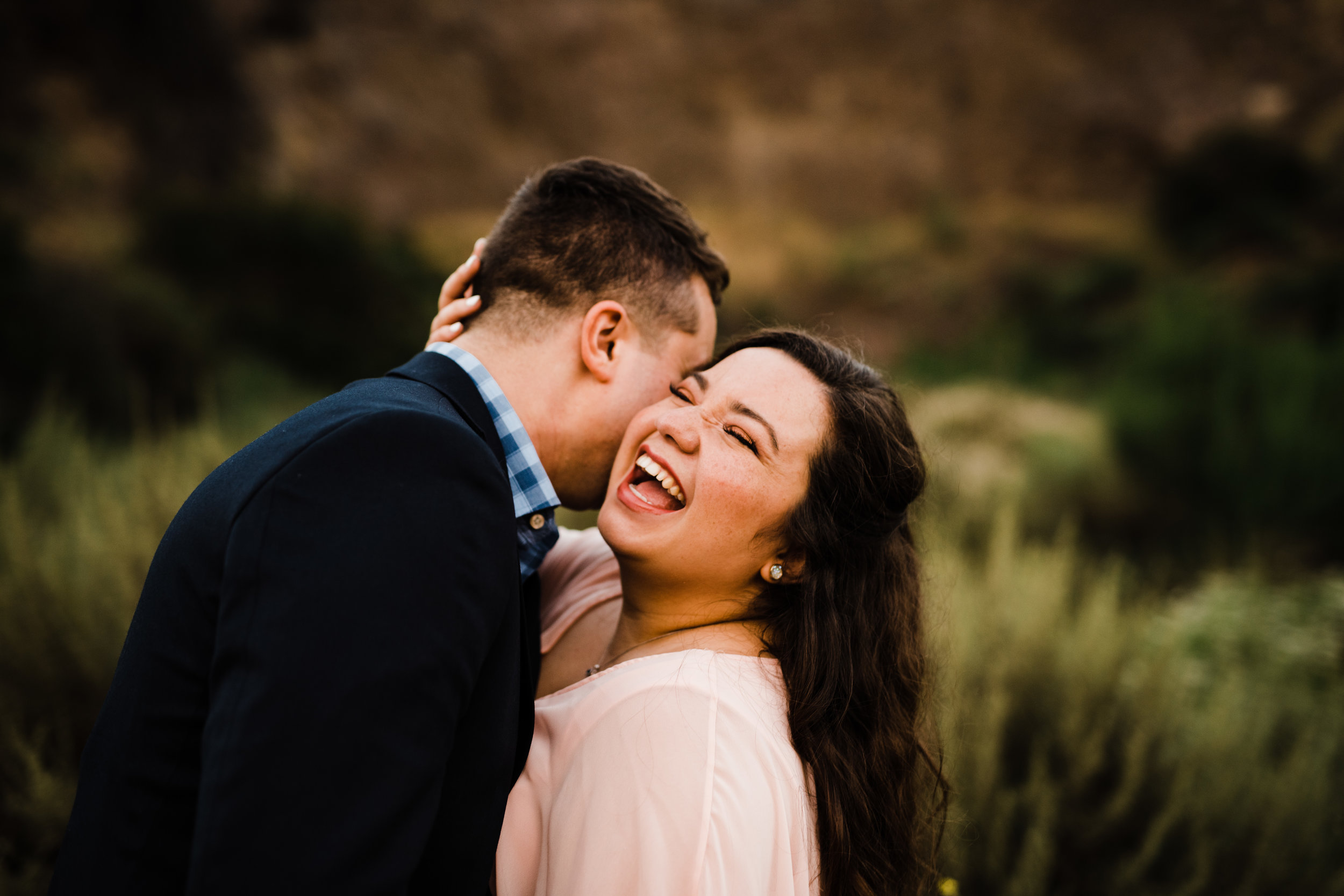 Laughing engaged couple at Bronson Canyon in Los Angeles, California