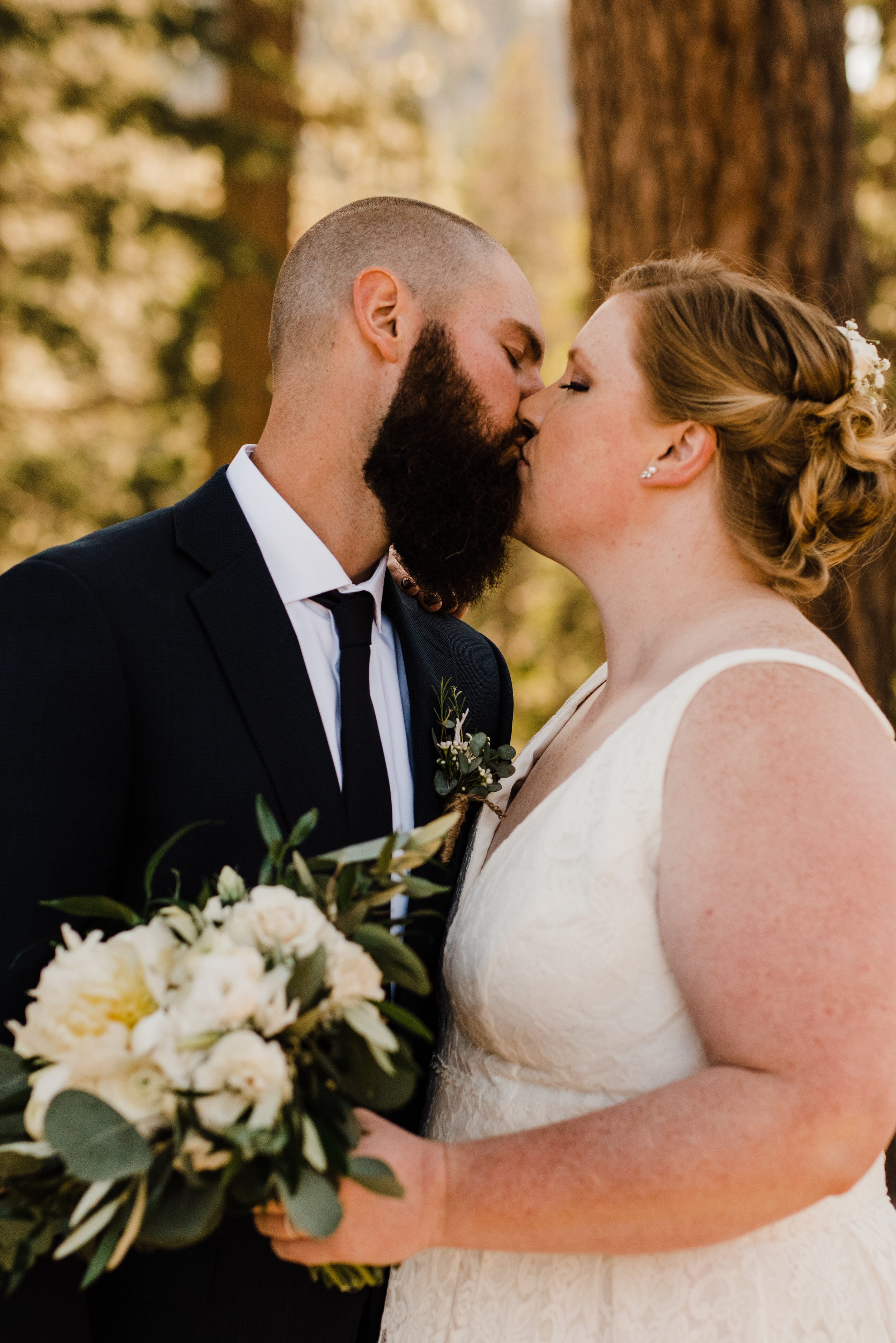 Summer Bride and Groom Kiss Beneath Trees at Yosemite National Park