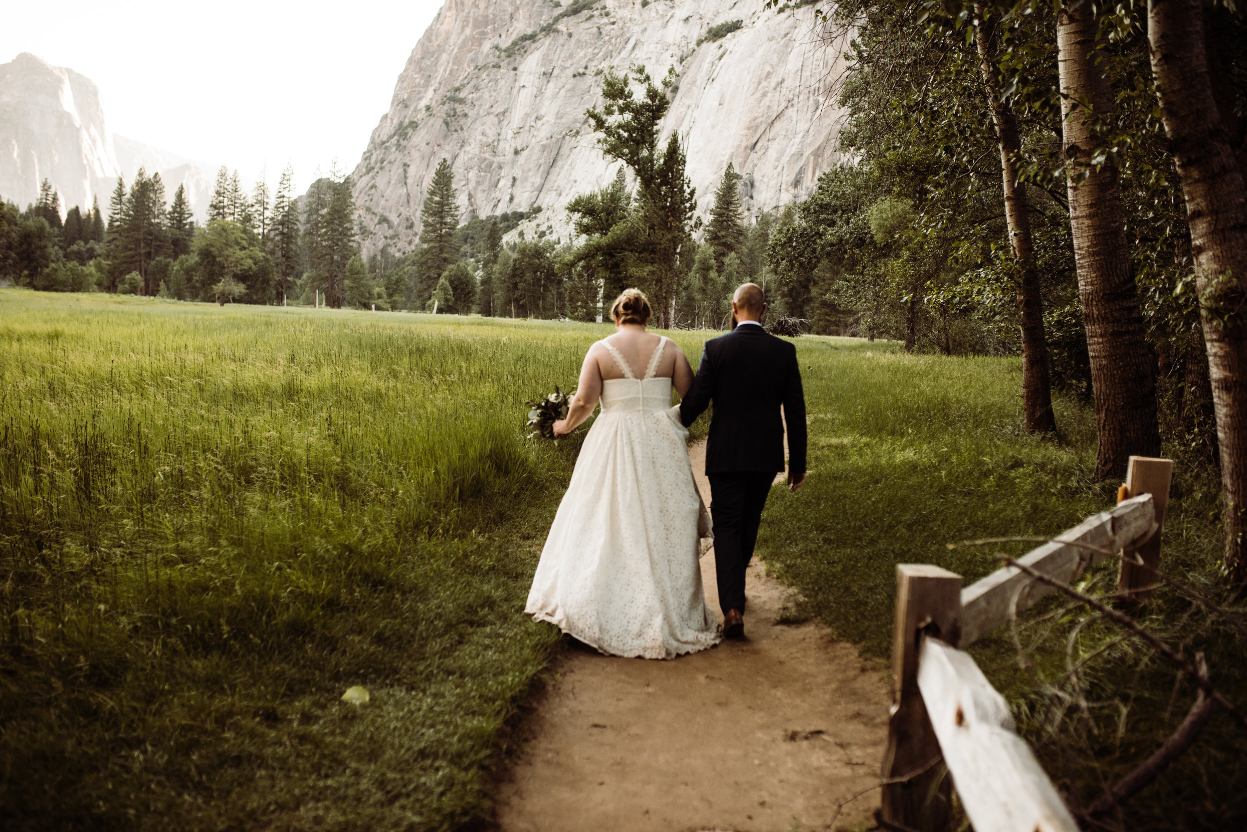 Couple walking on trail at Yosemite Valley after National Park elopement