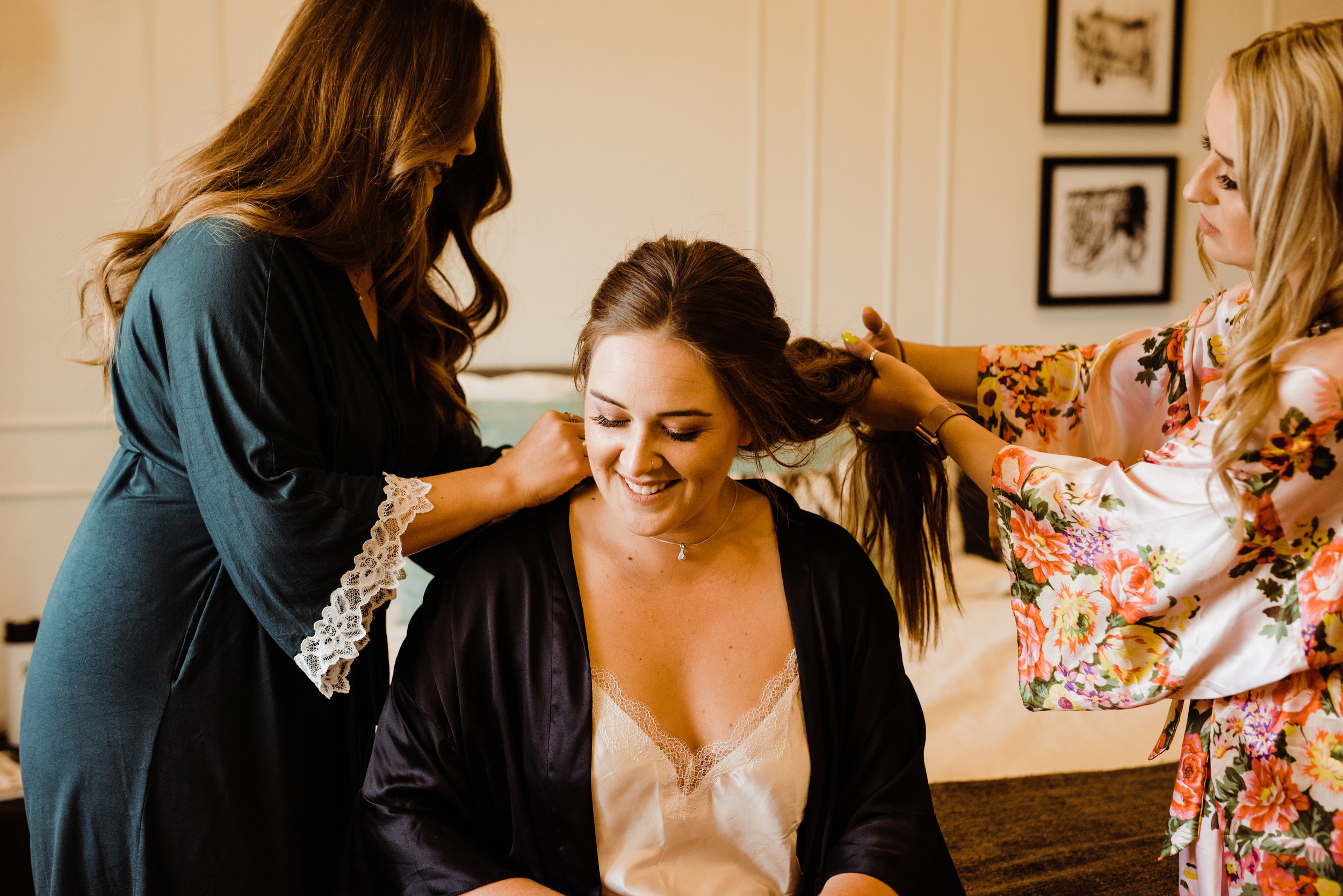 Sisters helping bride get ready at Serenity Escape JT on Joshua Tree Wedding Day
