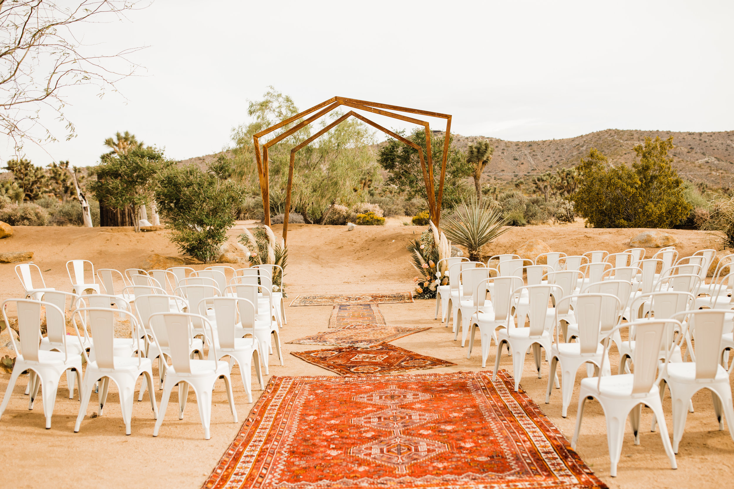 Tumbleweed Sanctuary and Garden Wedding Venue with Bohemian Distressed Rugs in Red and Orange Desert Color Scheme