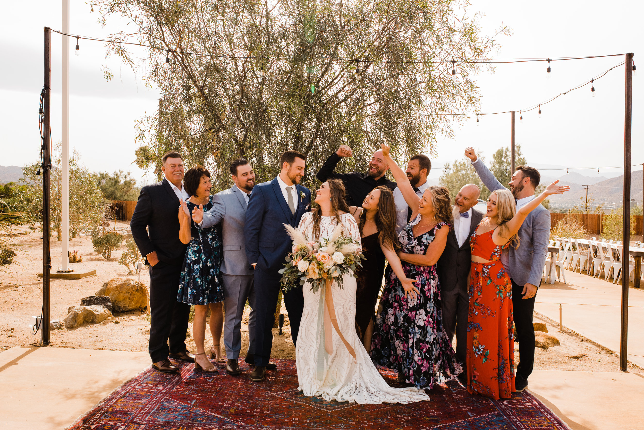 Family Cheers in Group Photo at Tumbleweed Sanctuary and Garden in Yucca Valley, California.