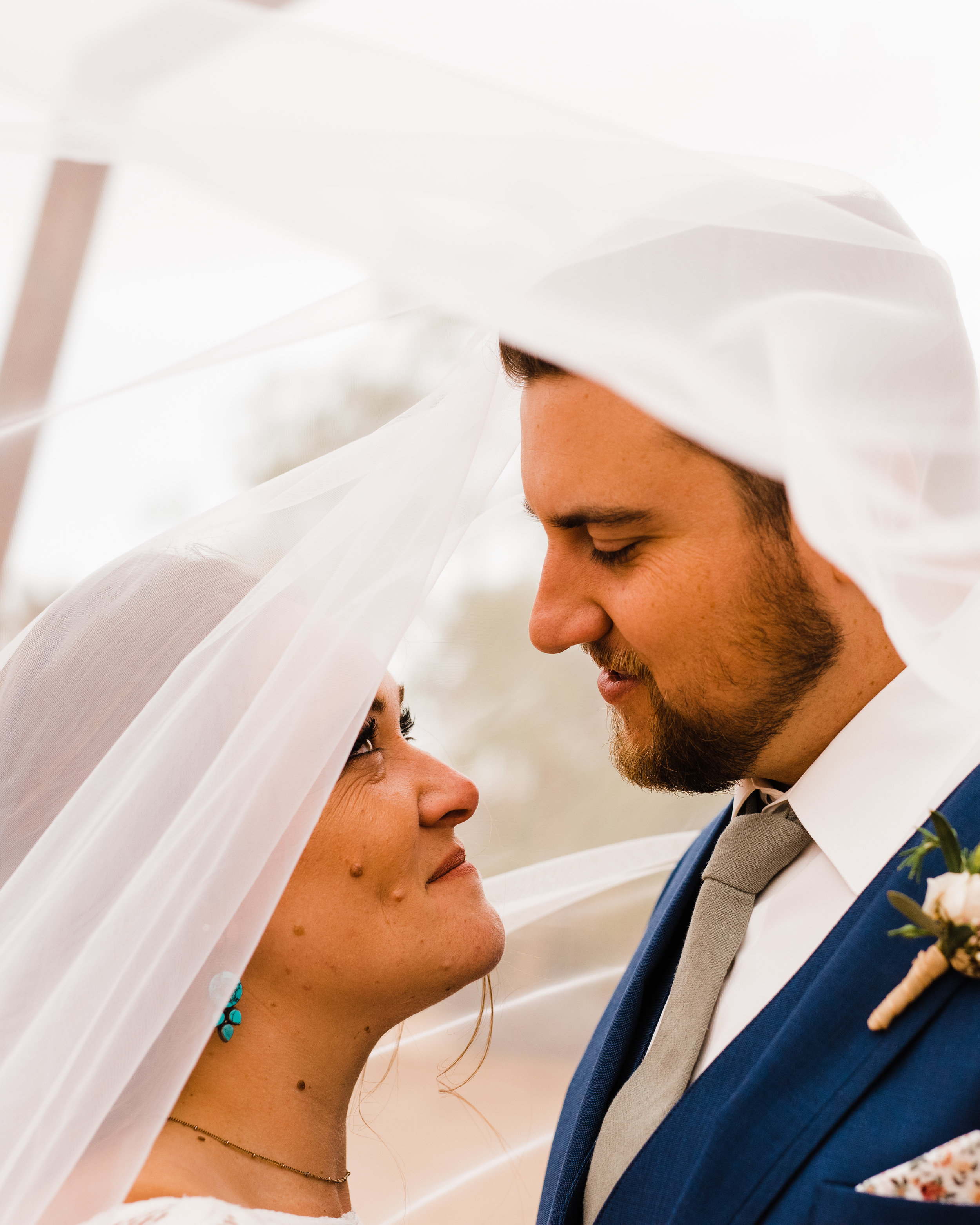 Bride and groom beneath veil at Tumbleweed Sanctuary wedding