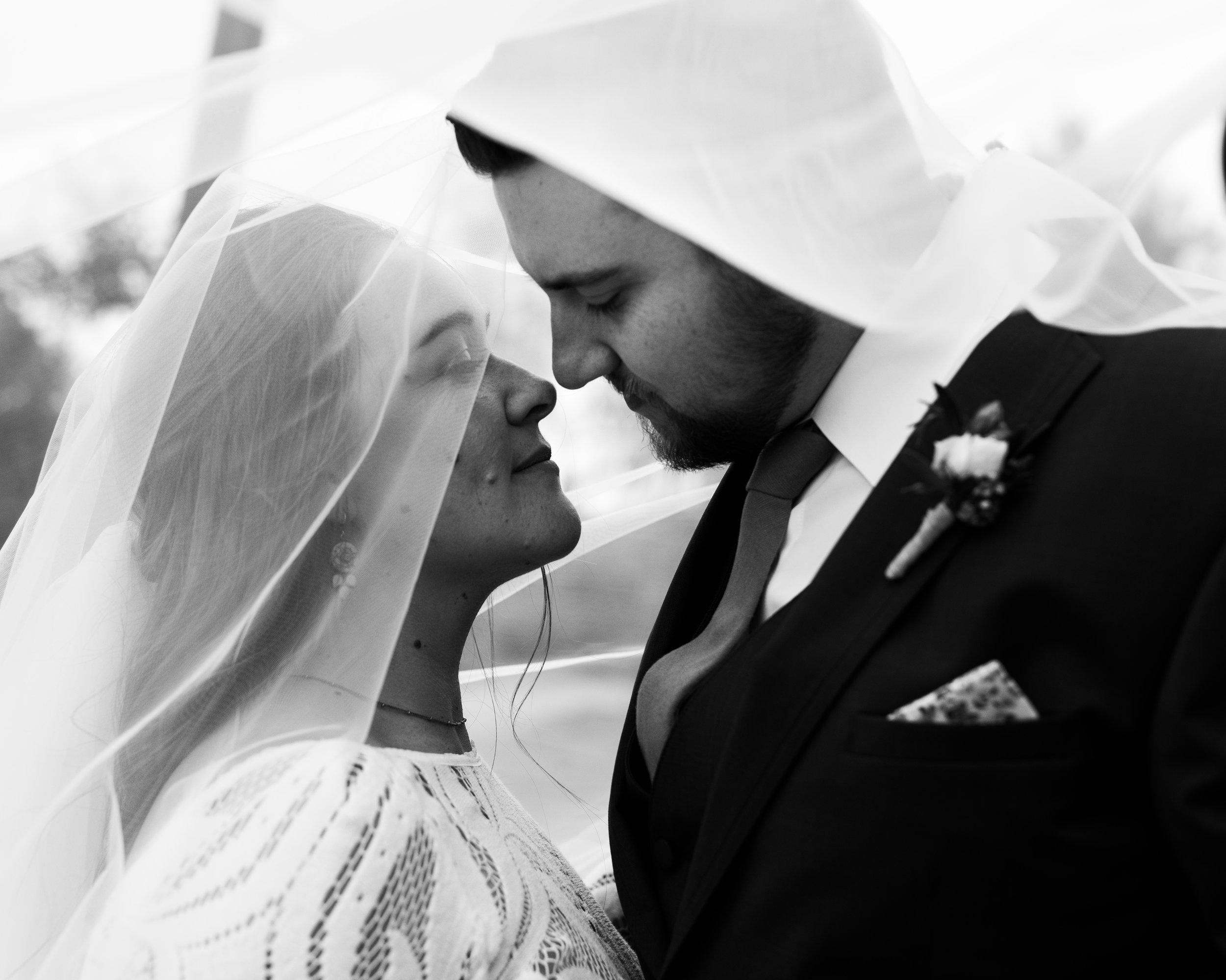 Bride and groom beneath veil at tumbleweed sanctuary wedding