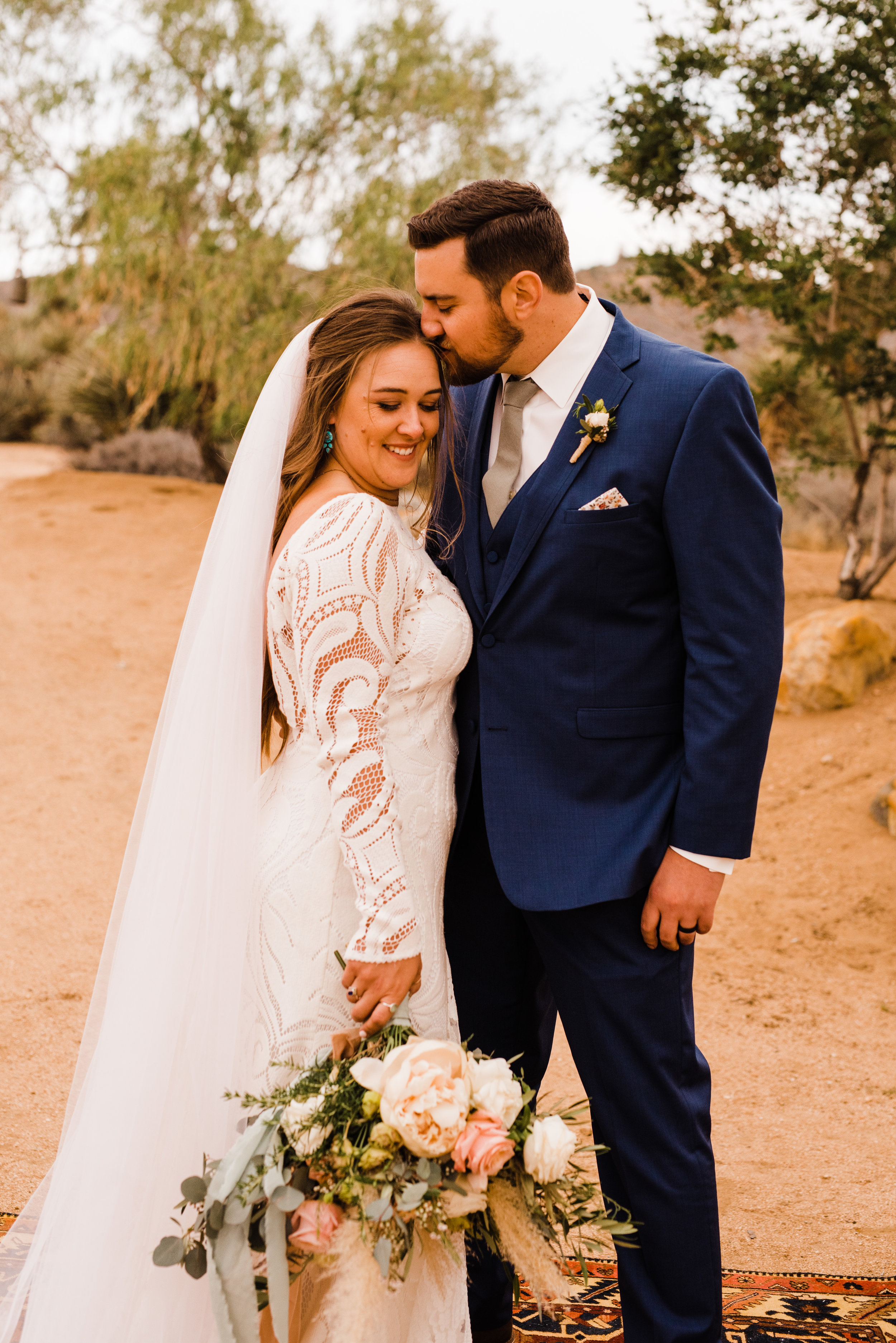 groom gives forehead kisses to bride at tumbleweed sanctuary wedding