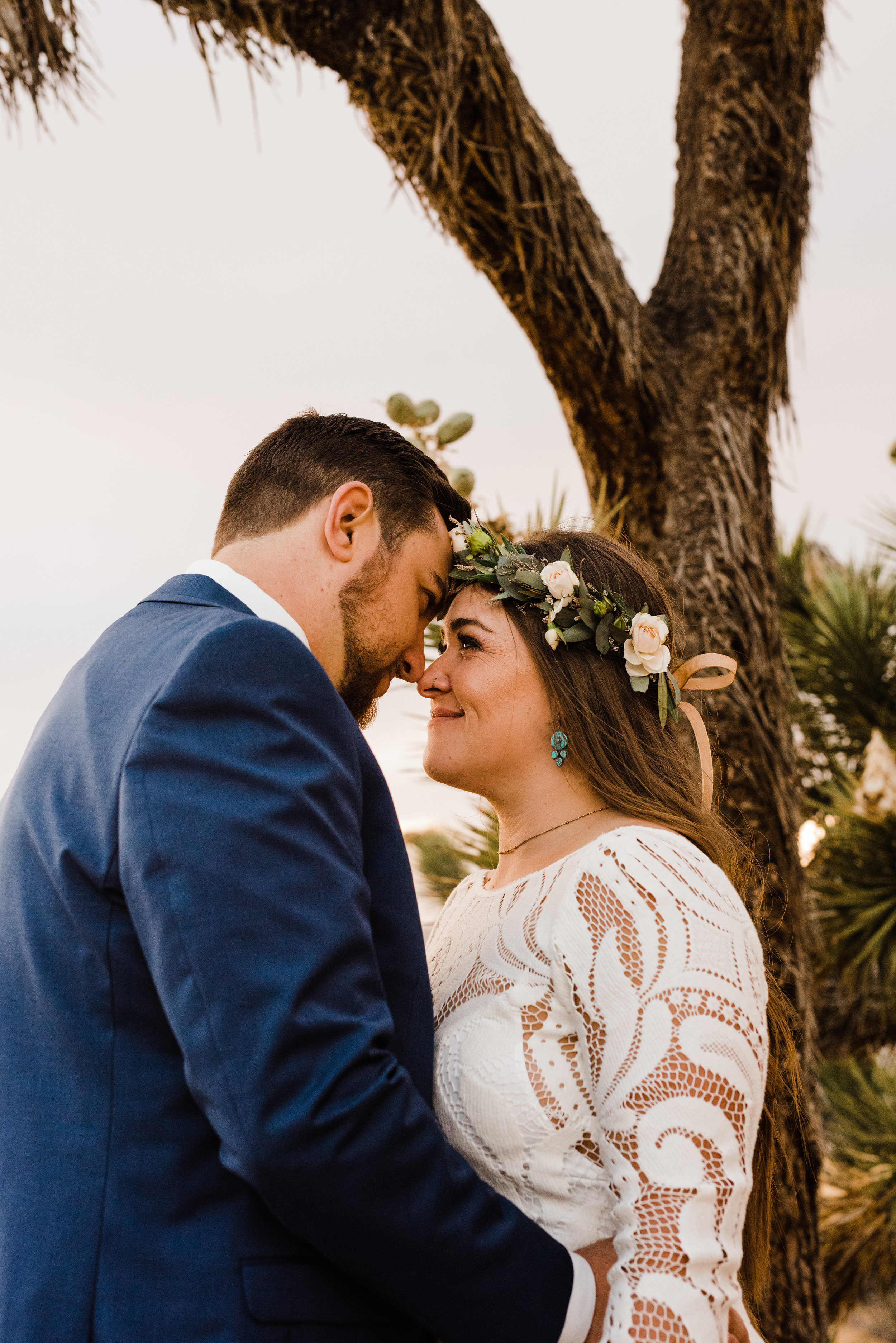 bride and groom beneath Joshua Tree in Yucca Valley