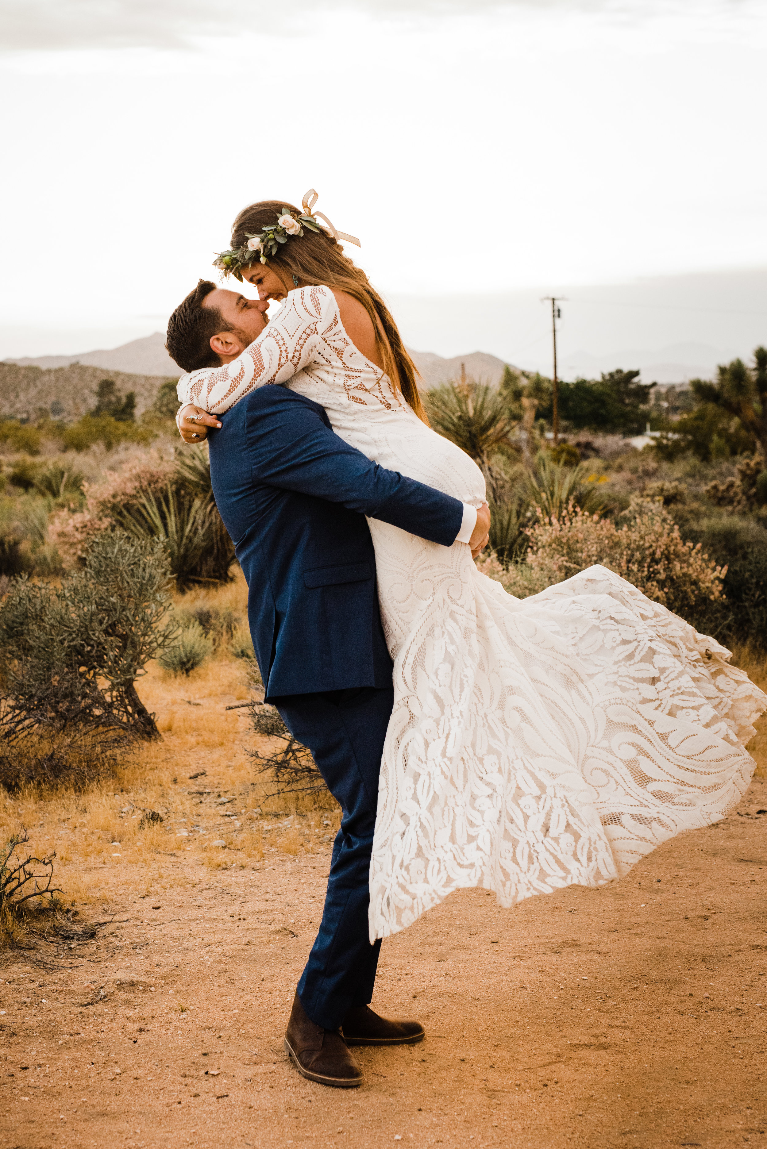 Groom picking up bride in Joshua Tree desert at Tumbleweed Sanctuary Wedding Venue