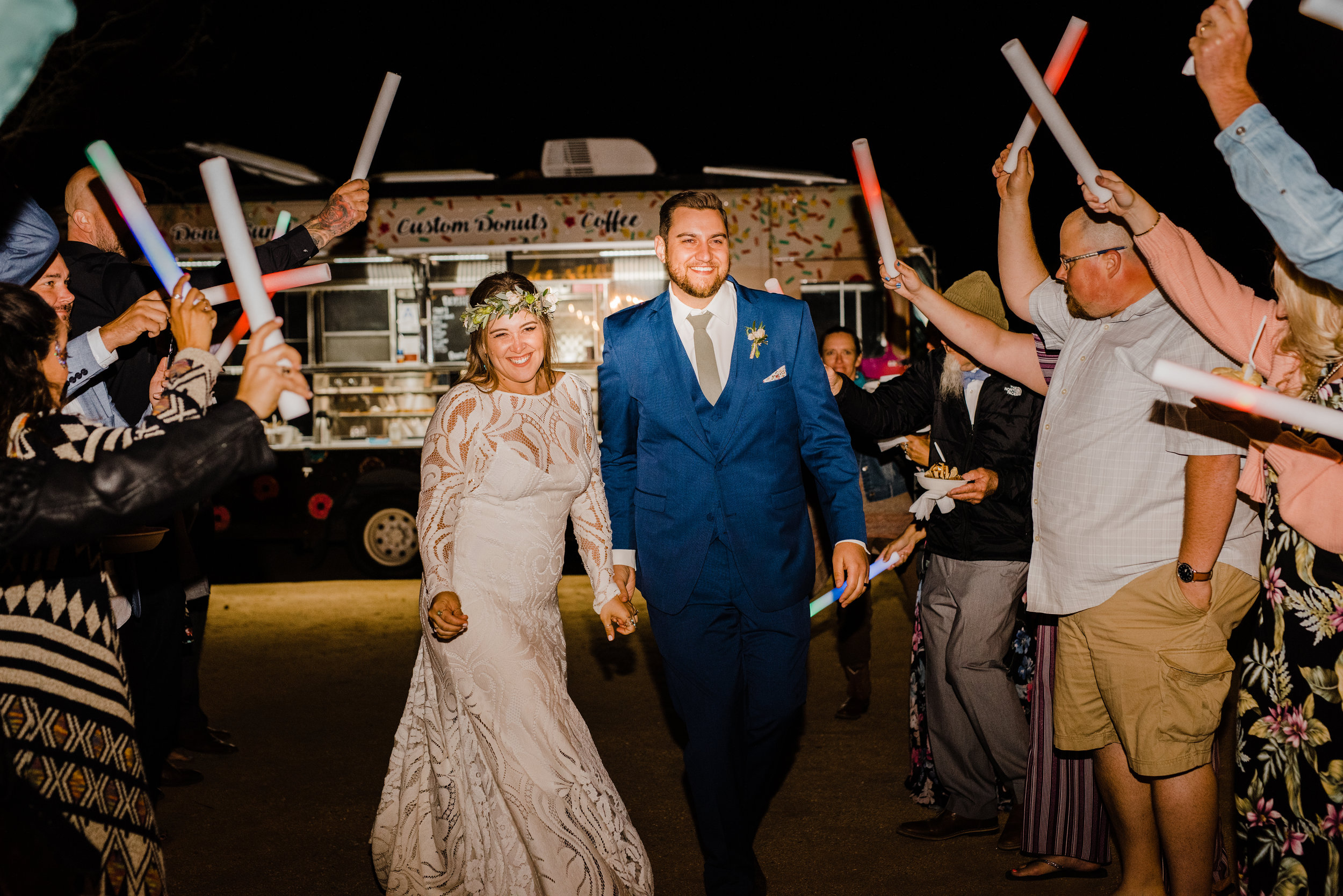Bride and groom exit with glow sticks at Joshua Tree venue Tumbleweed Sanctuary