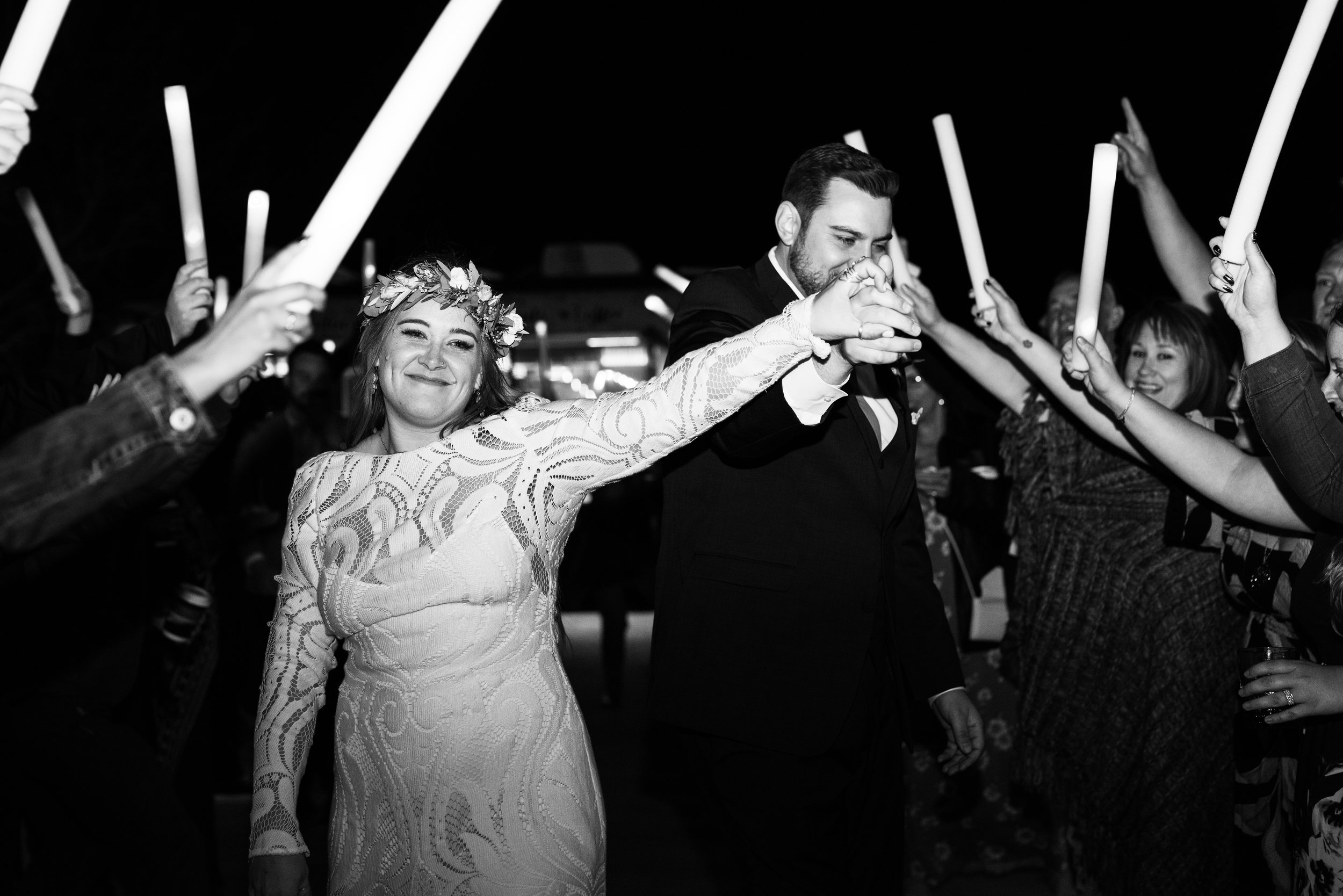 happy bride during glowstick wedding reception exit